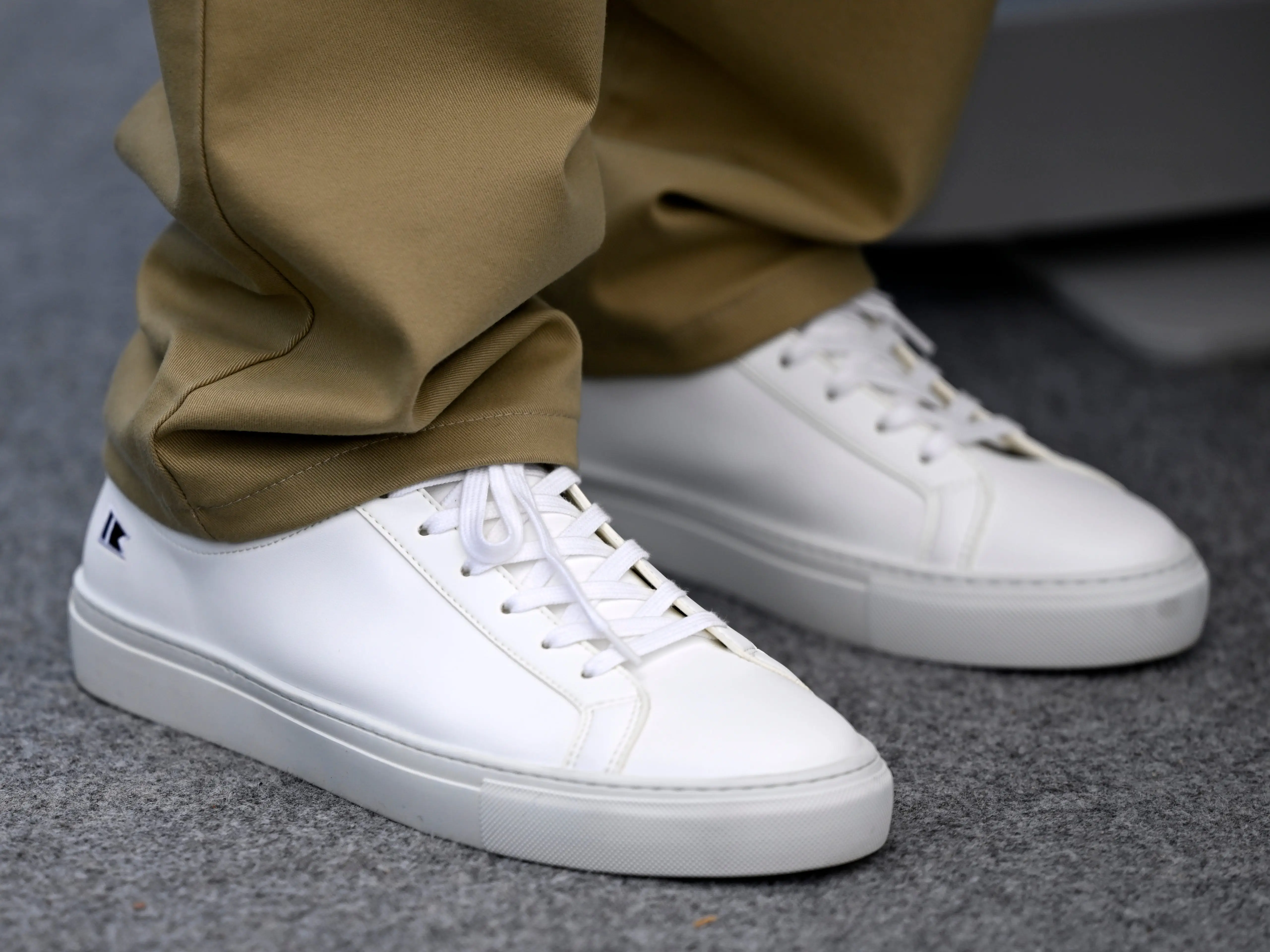 A close-up of a pair of all-white sneakers.