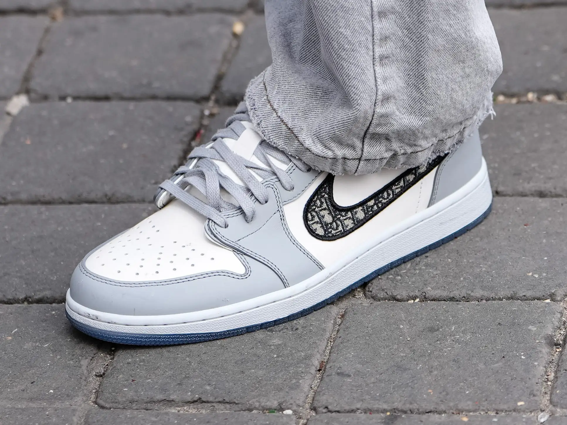 A close-up of a pair of Dior Jordan 1 Lows.