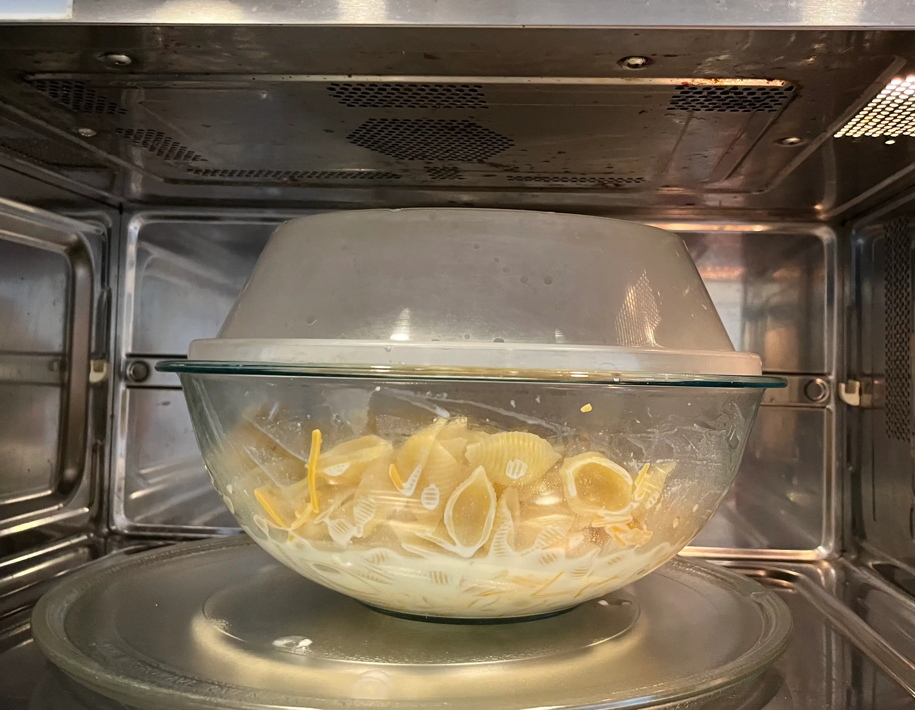 mac and cheese in glass bowl in microwave