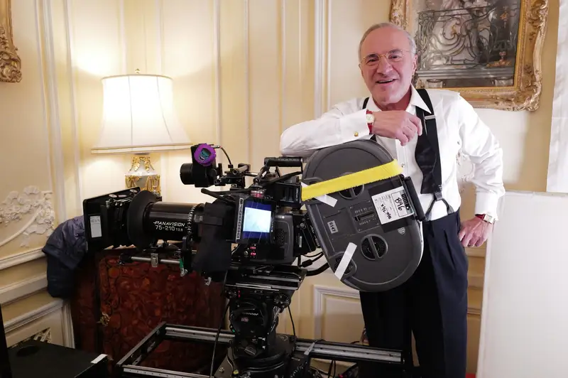 Kevin O'Leary leanging against a camera