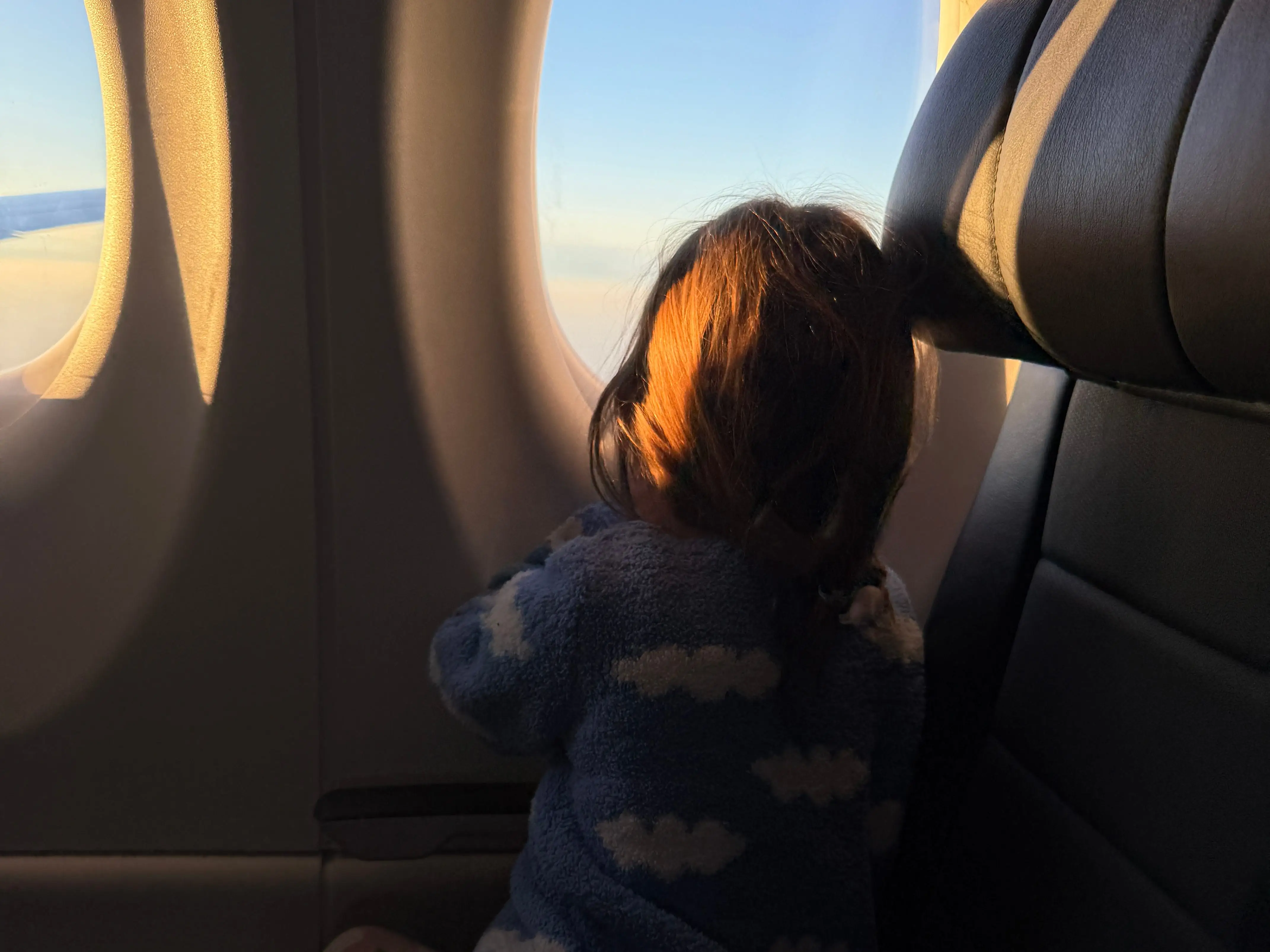Child looking out plane window
