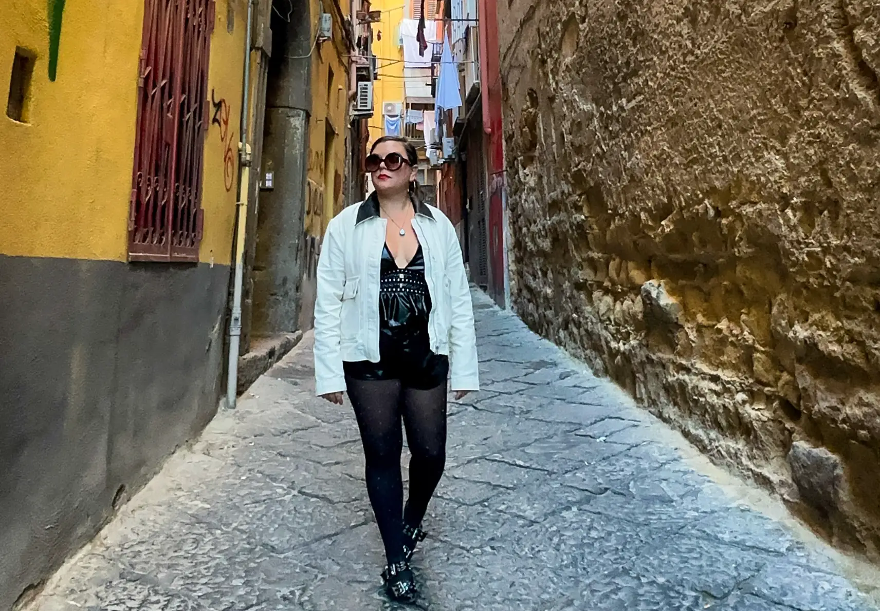 The writer strolling down an alleyway in Naples, Italy.