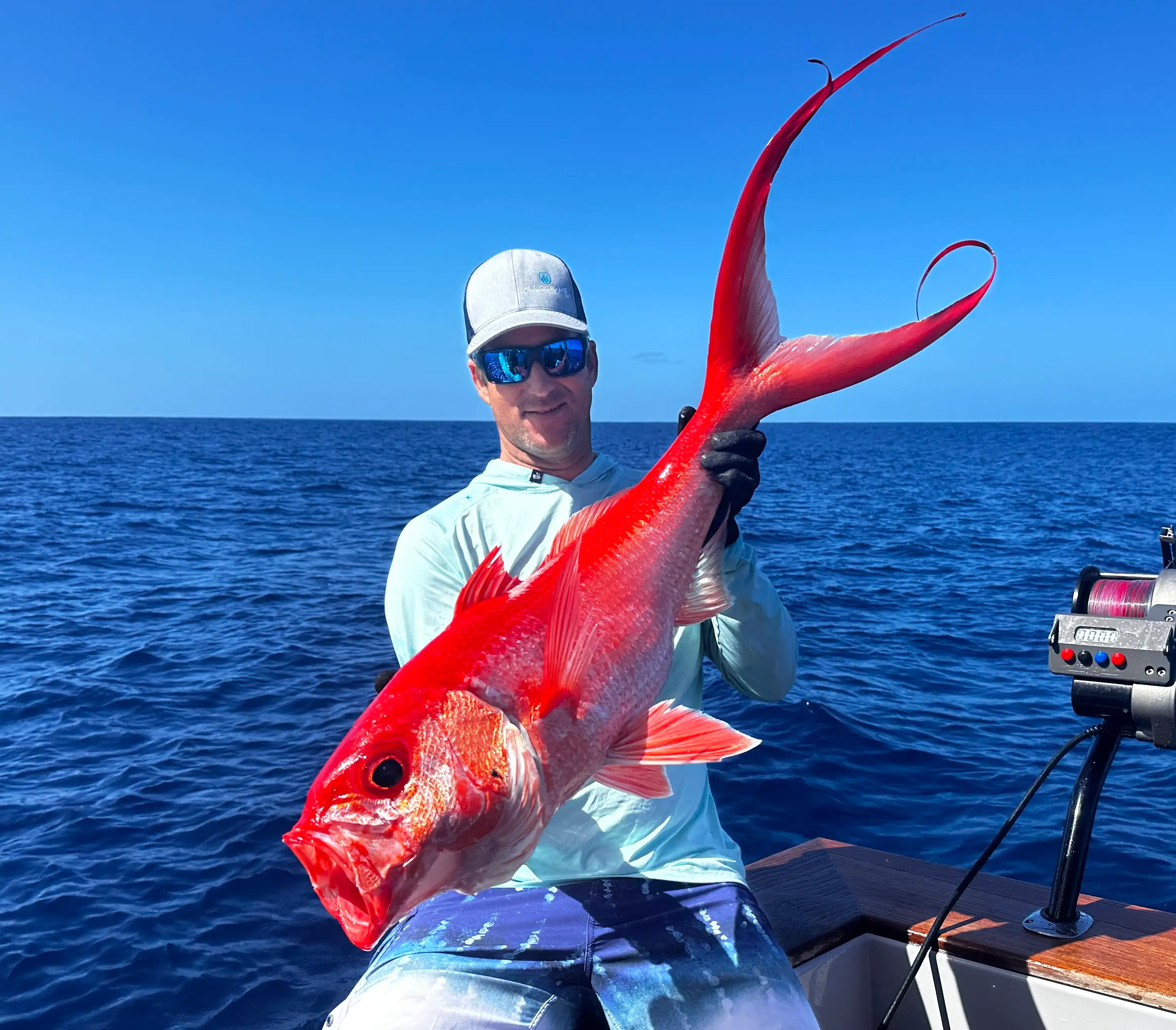 Cameron Kirkconnell with a large reddish pink fish.