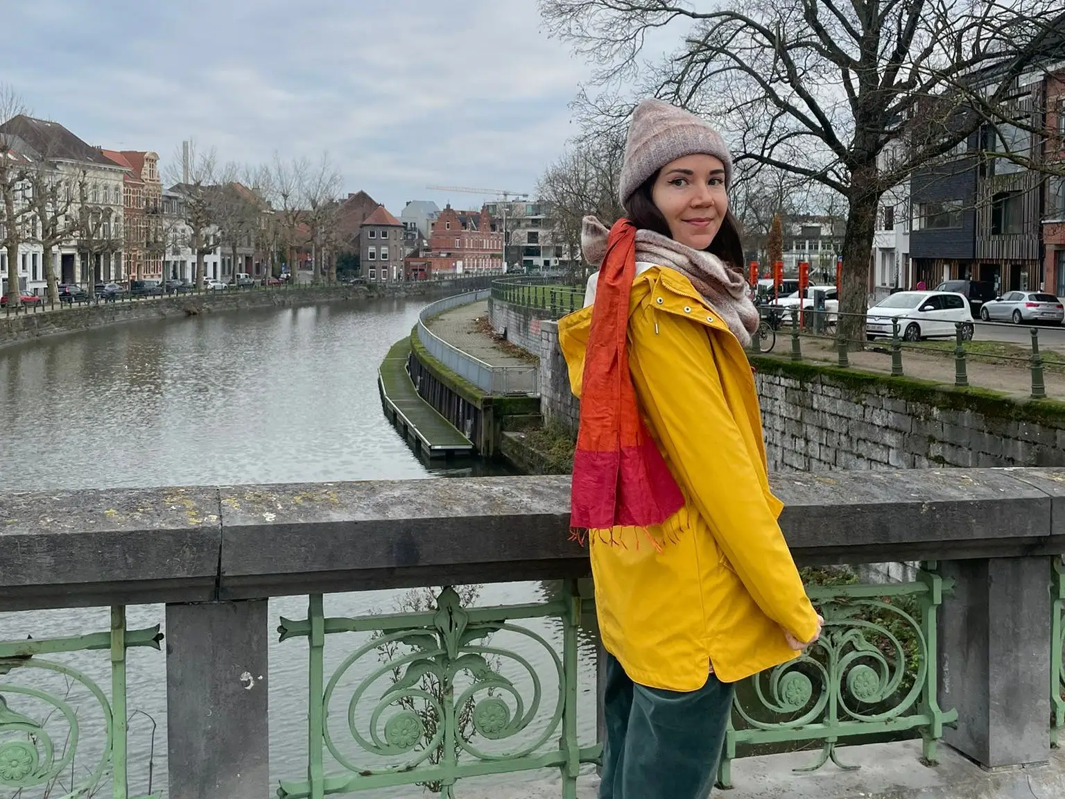The author posing in a yellow rain jacket in Belgium.