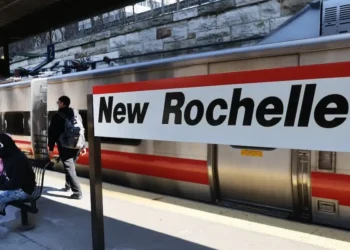 The mayor of a New York City suburb says building apartments on parking lots near train and bus stations is a key to reining in rent