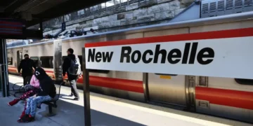 The mayor of a New York City suburb says building apartments on parking lots near train and bus stations is a key to reining in rent