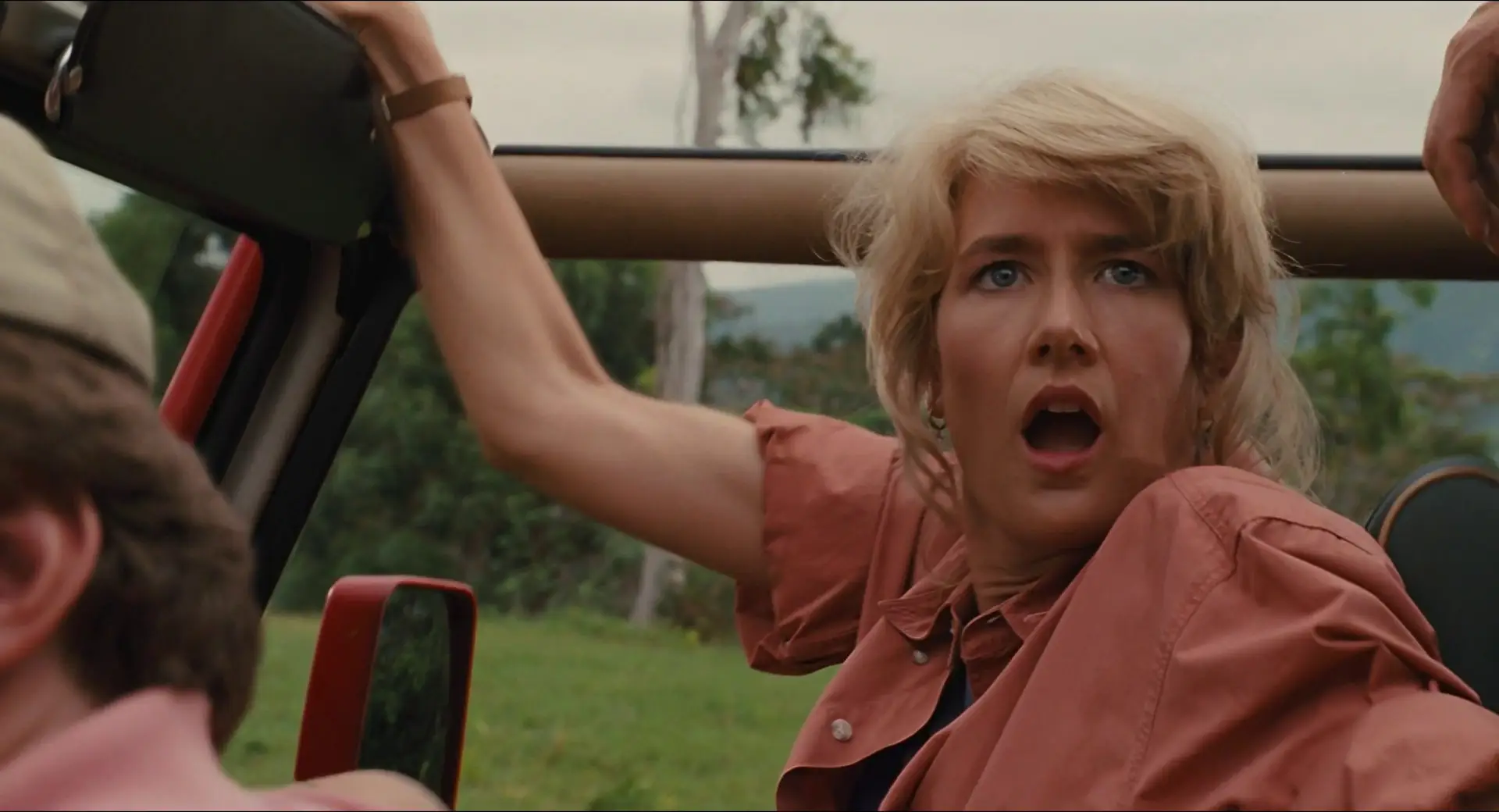 Laura Dern with shocking look while sitting in a jeep