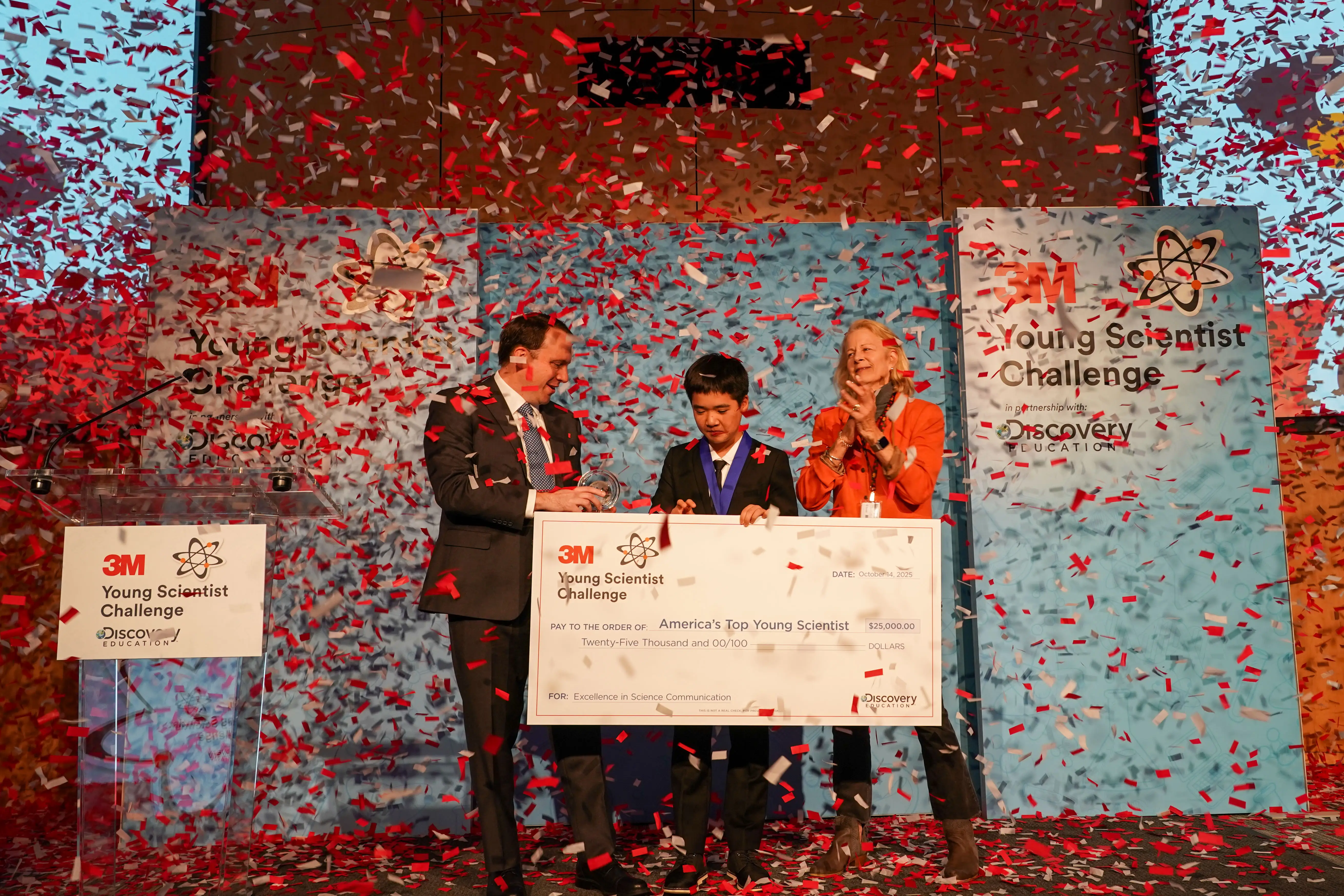 Kevin Tang on stage after winning first place at 3M Young Scientist Challenge.