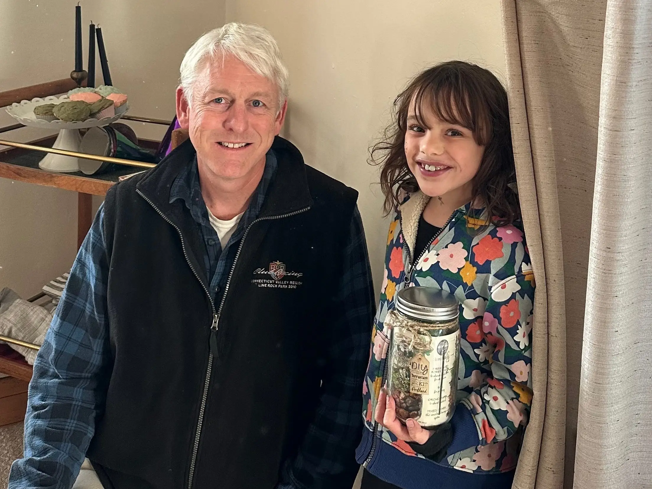 The author's daughter poses with a local shop owner at her birthday party.