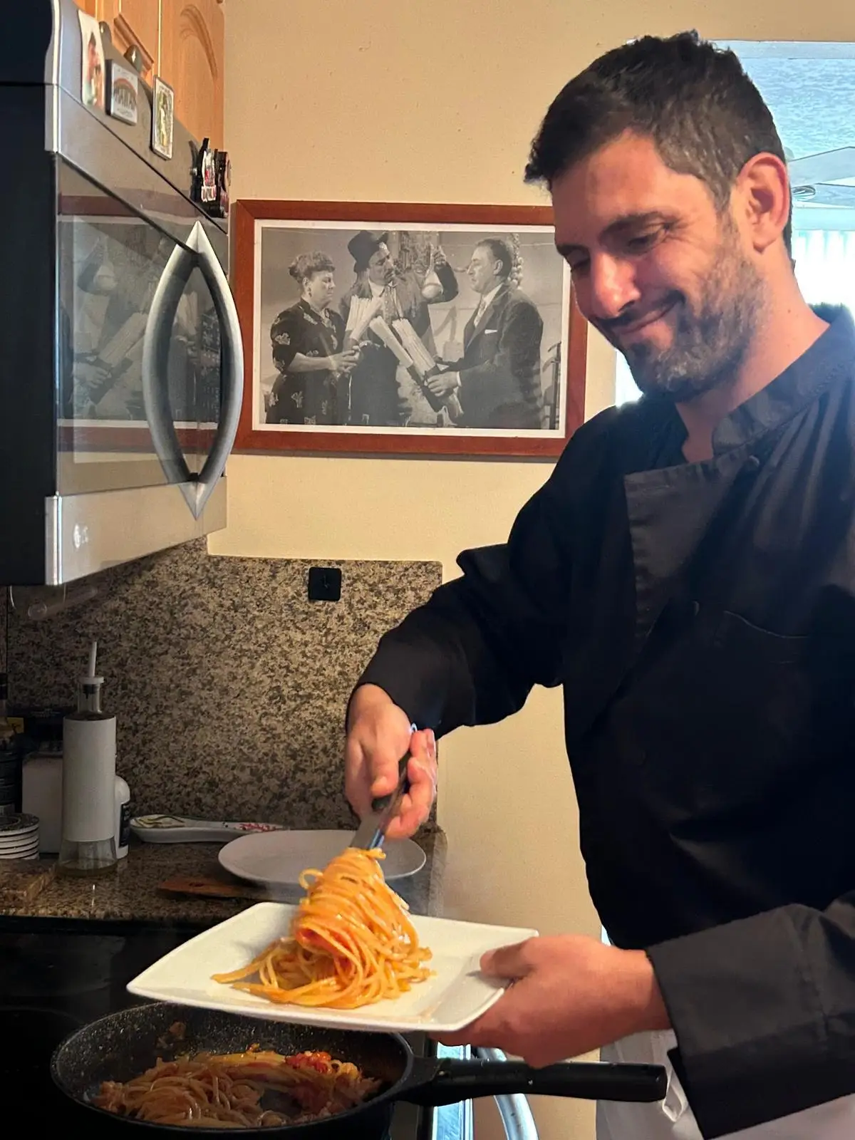 Diego Sabino cooking pasta for his son.