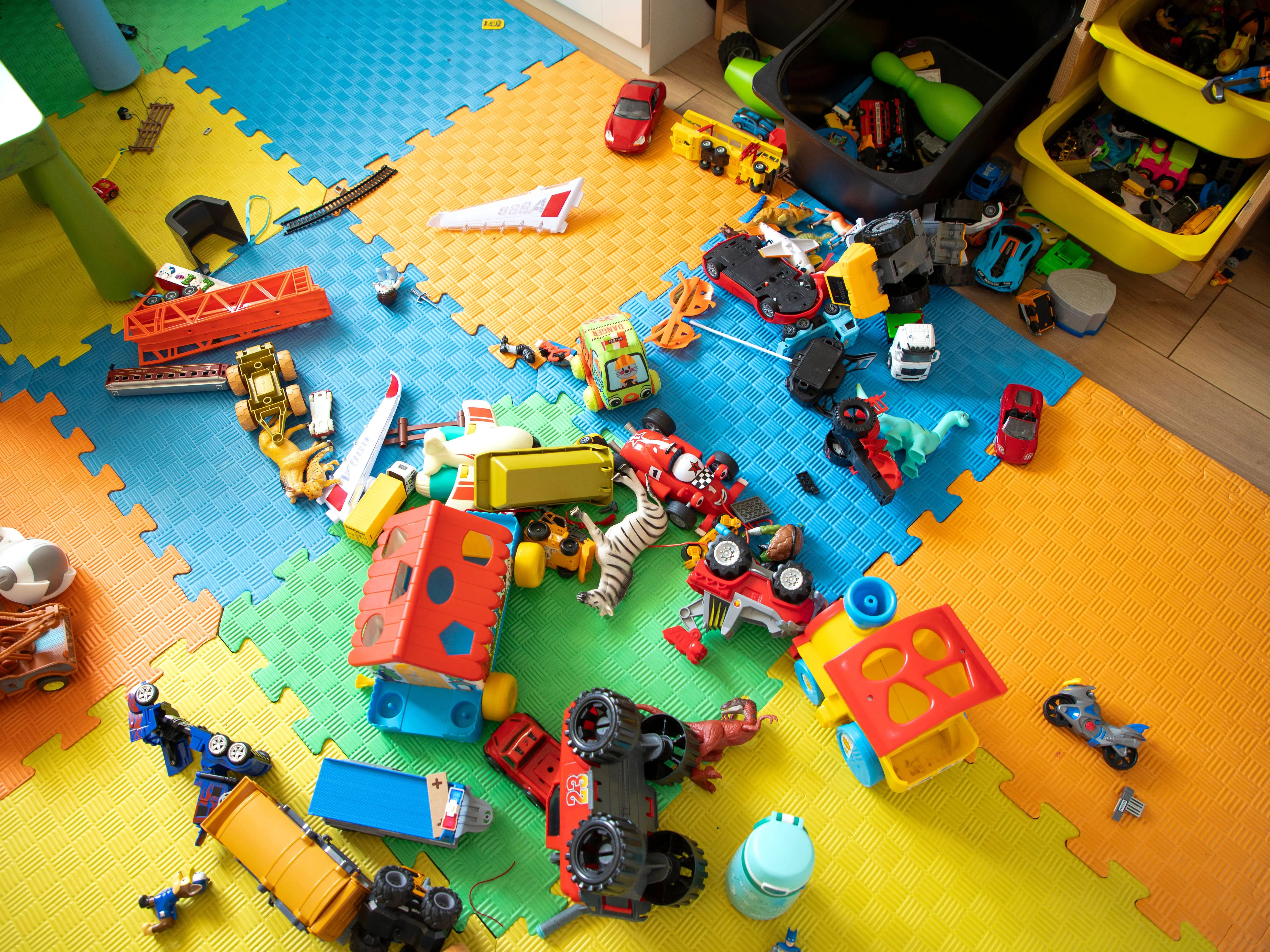 A colorful mat covered in toys.