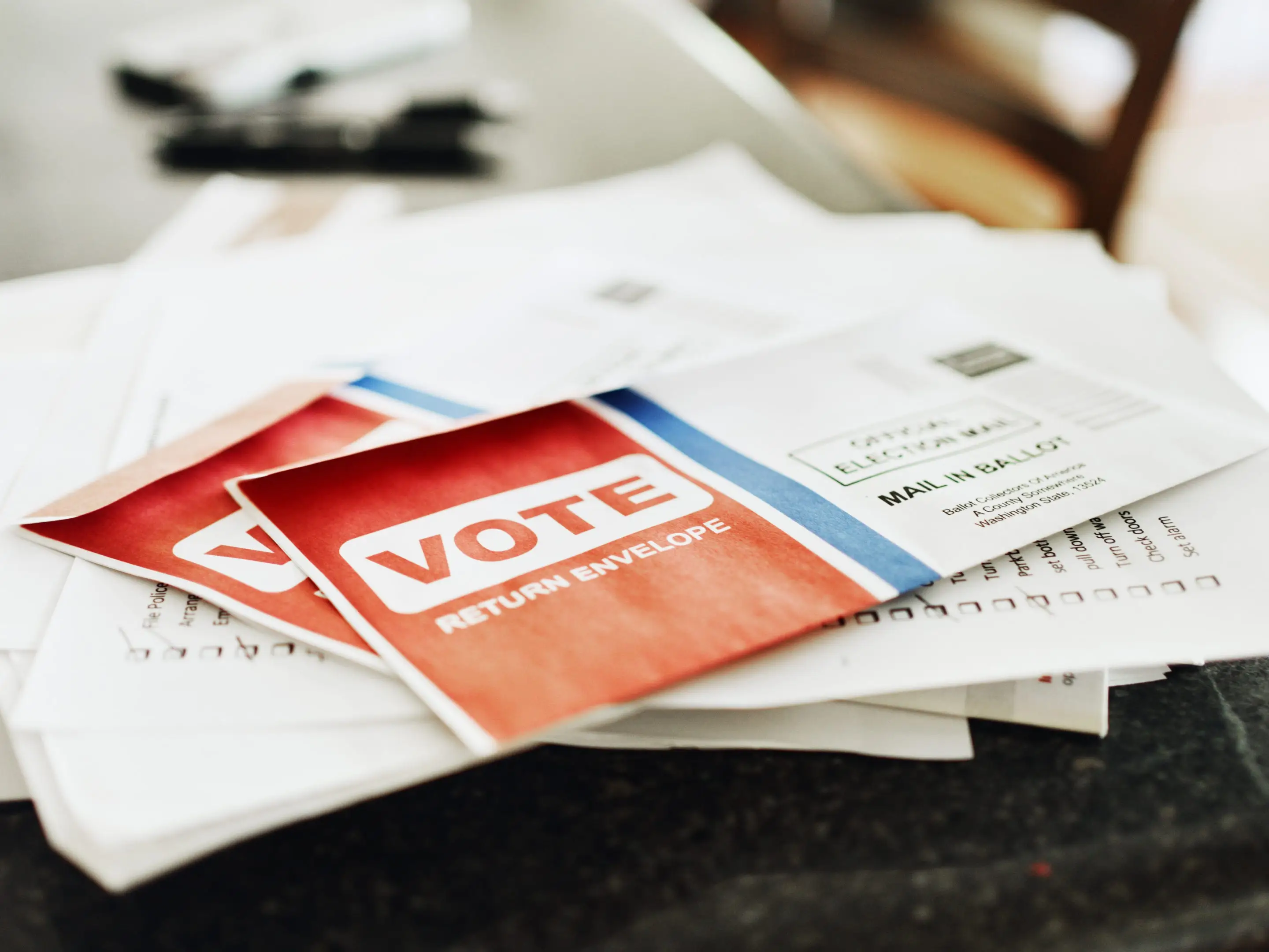 A stack of mail on a table.