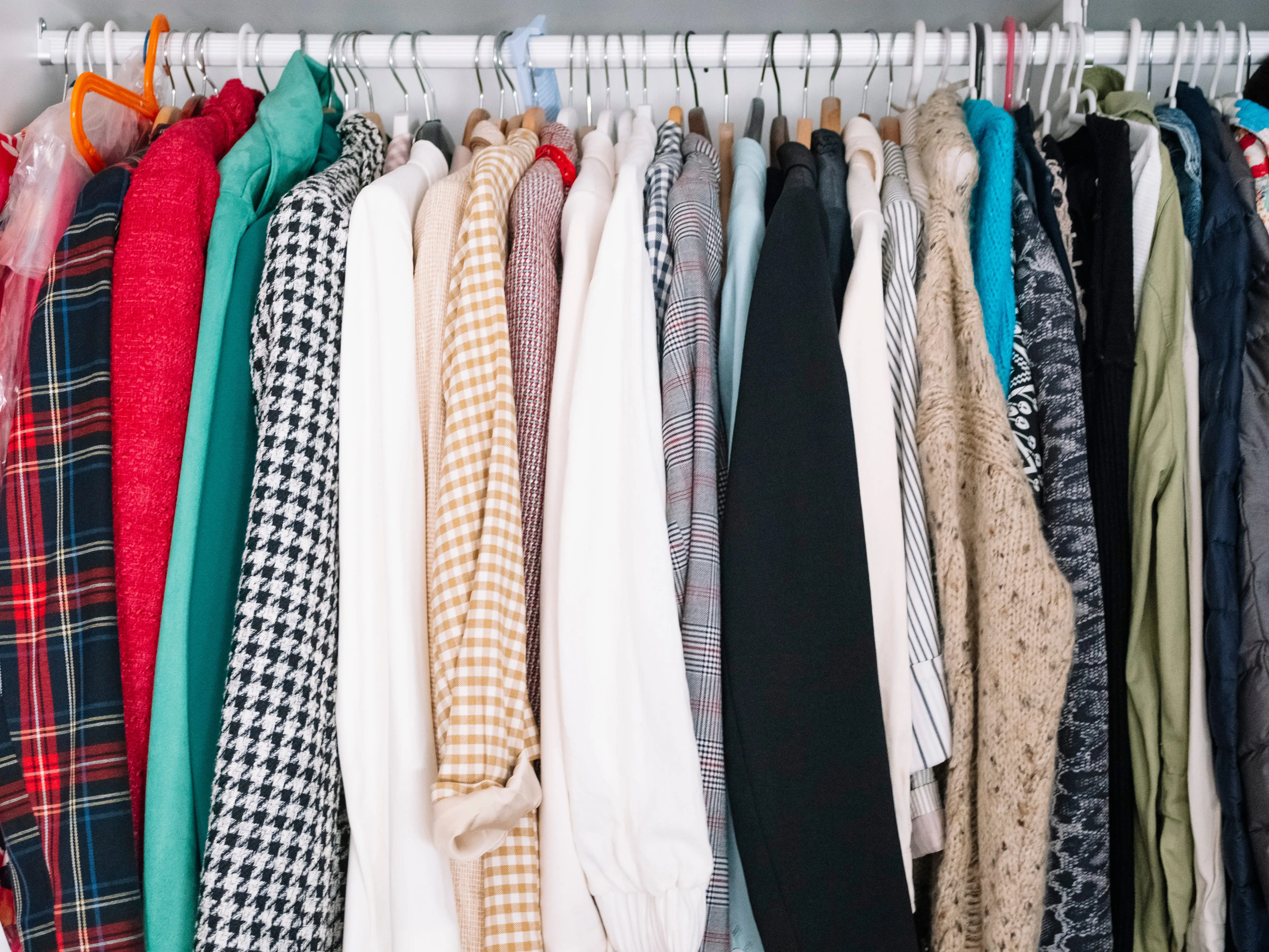Women's clothing hanging in a closet.