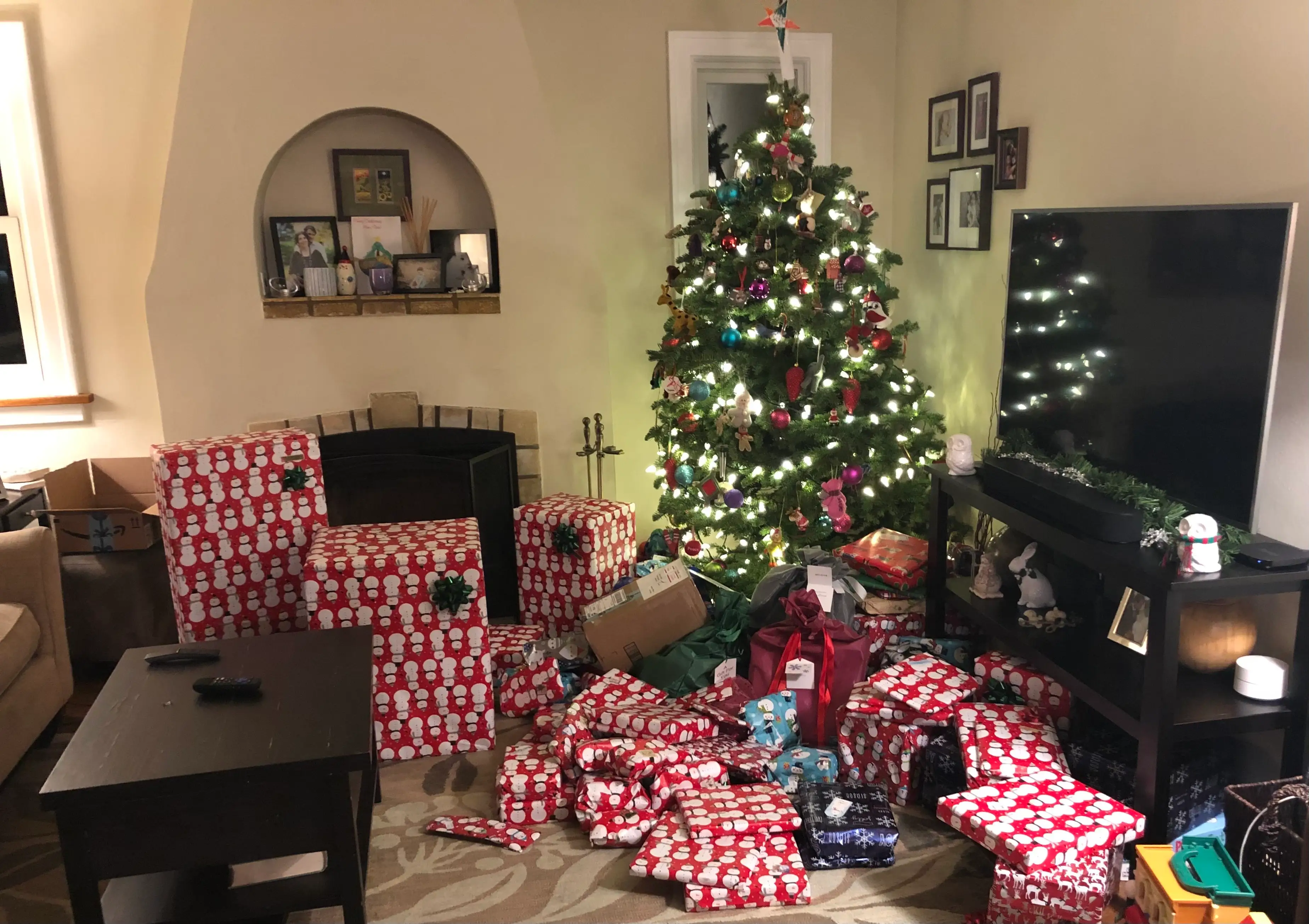 a christmas tree with a lot of presents in front of it