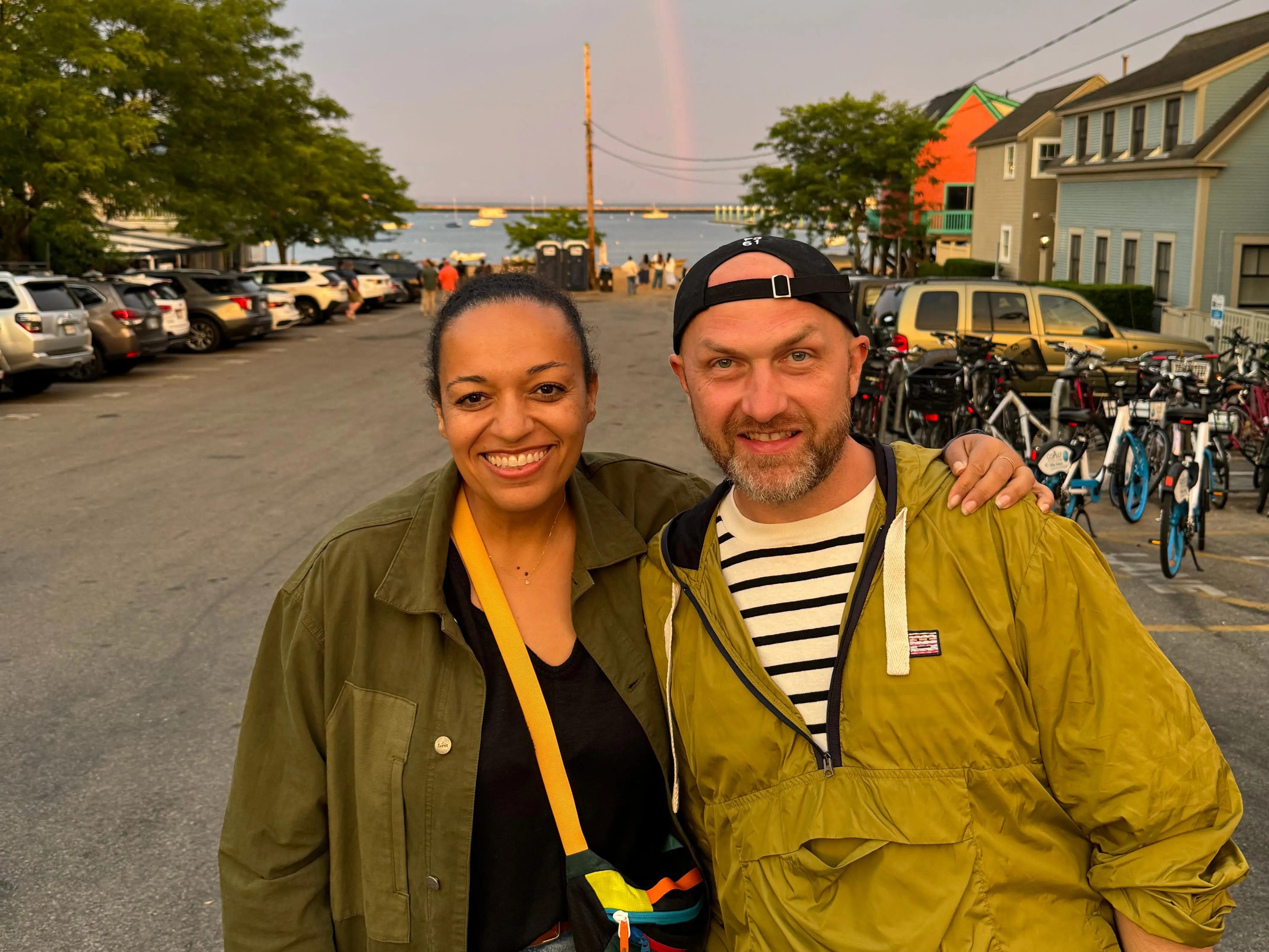 Wade and Selena Lounds stand in front of a rainbow.
