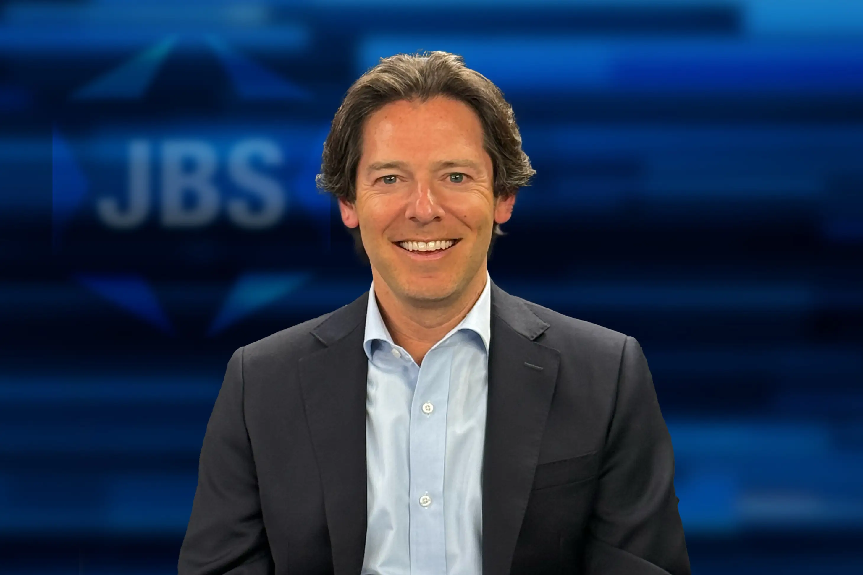 Justin Pines in front of JBS sign