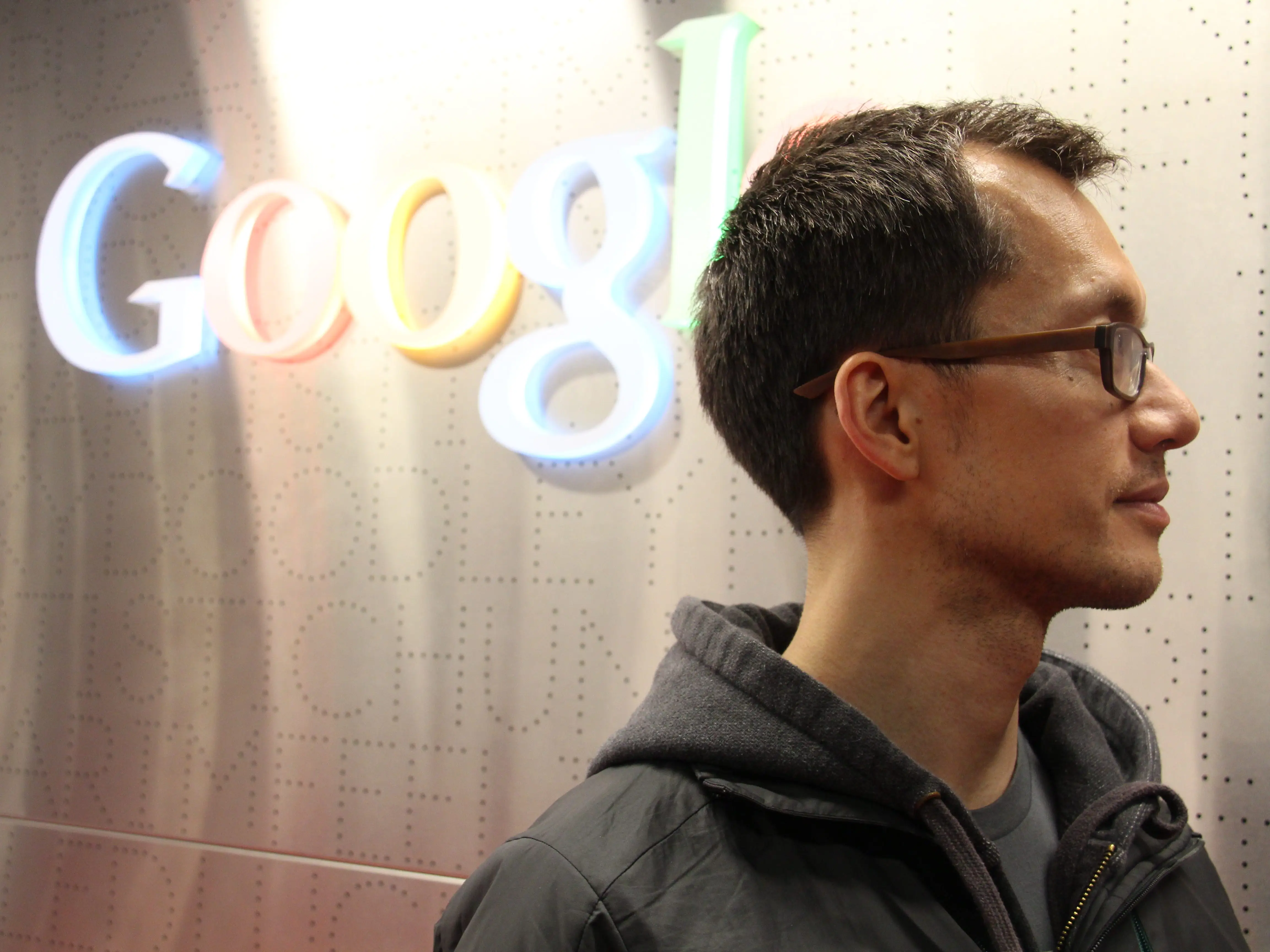 Patrick Leung standing in front of a Google sign