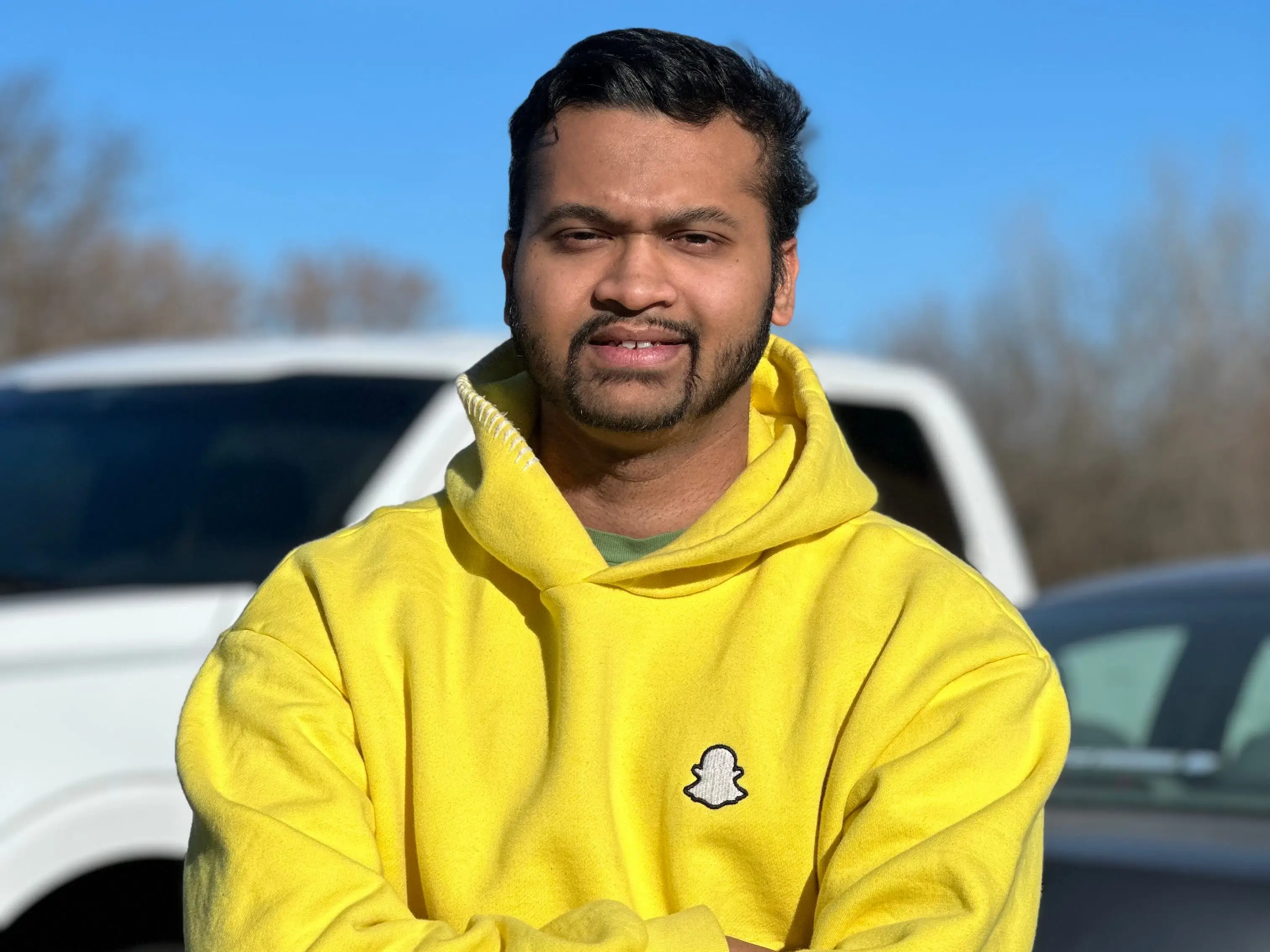 Mostofa Shakib wearing a yellow Snapchat hoodie