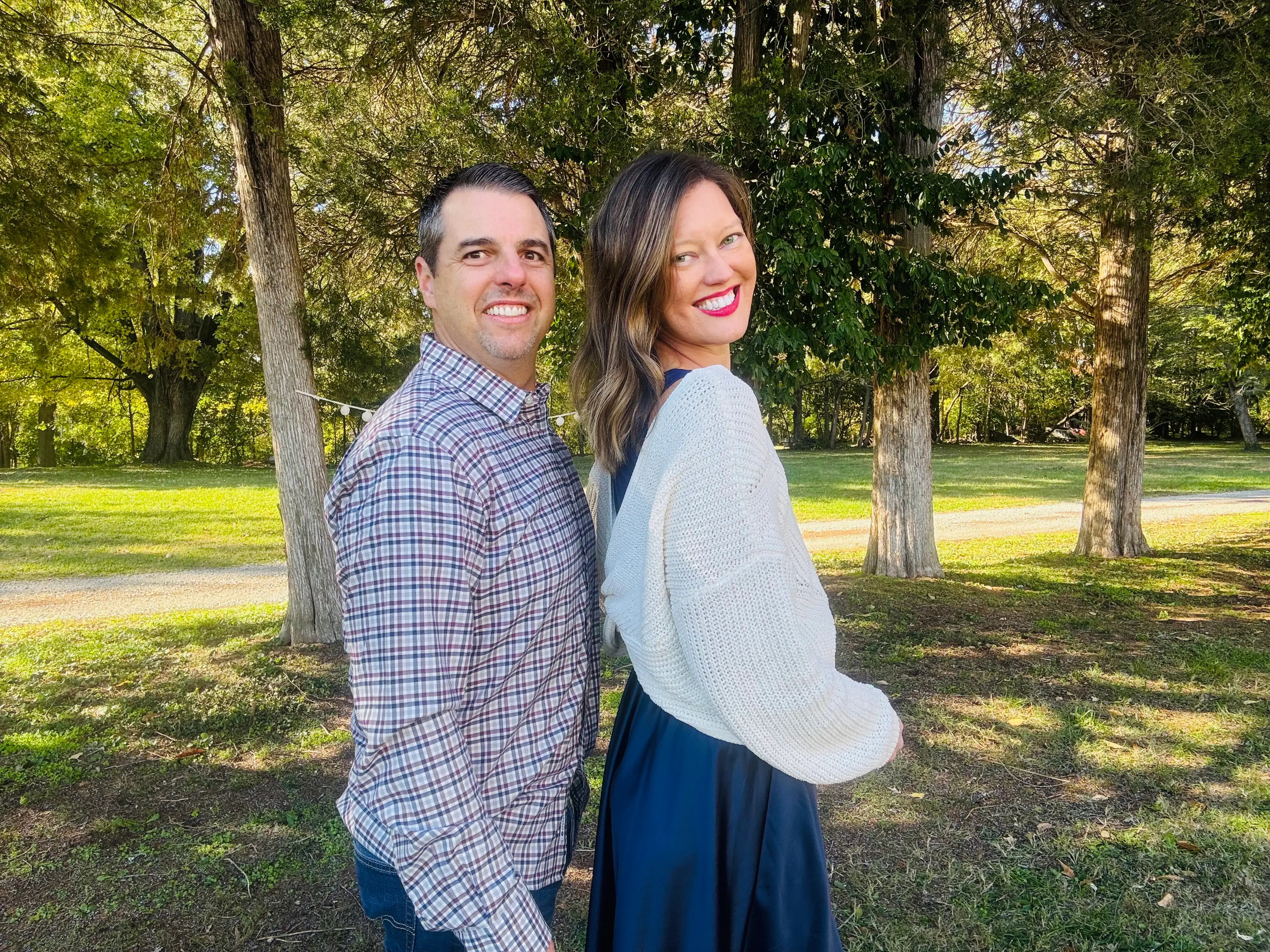 The author and her husband pose outside in front of a tree.