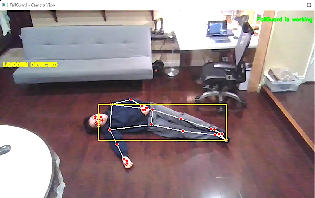A person lying on the ground is outlined with a yellow box.