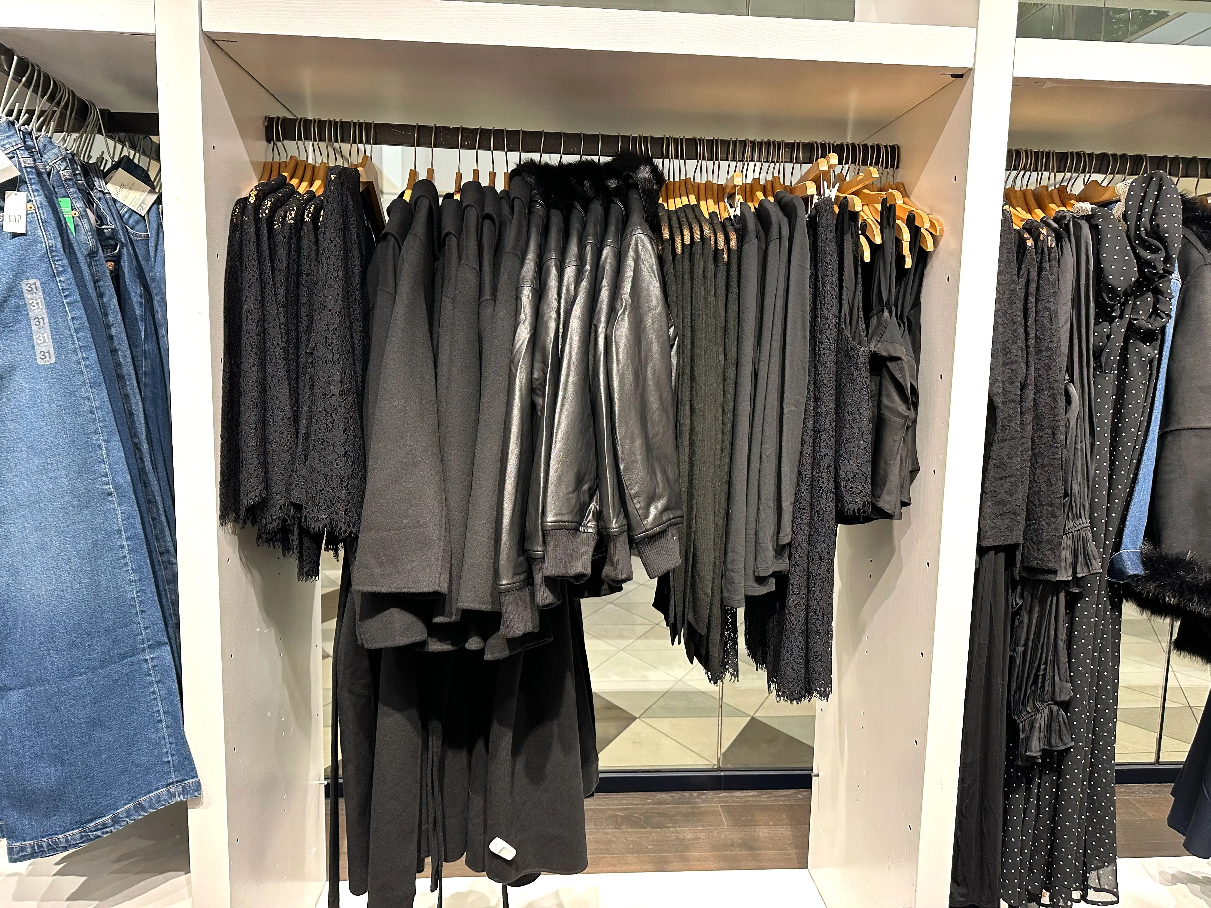 A rack of black clothing on display at Gap.