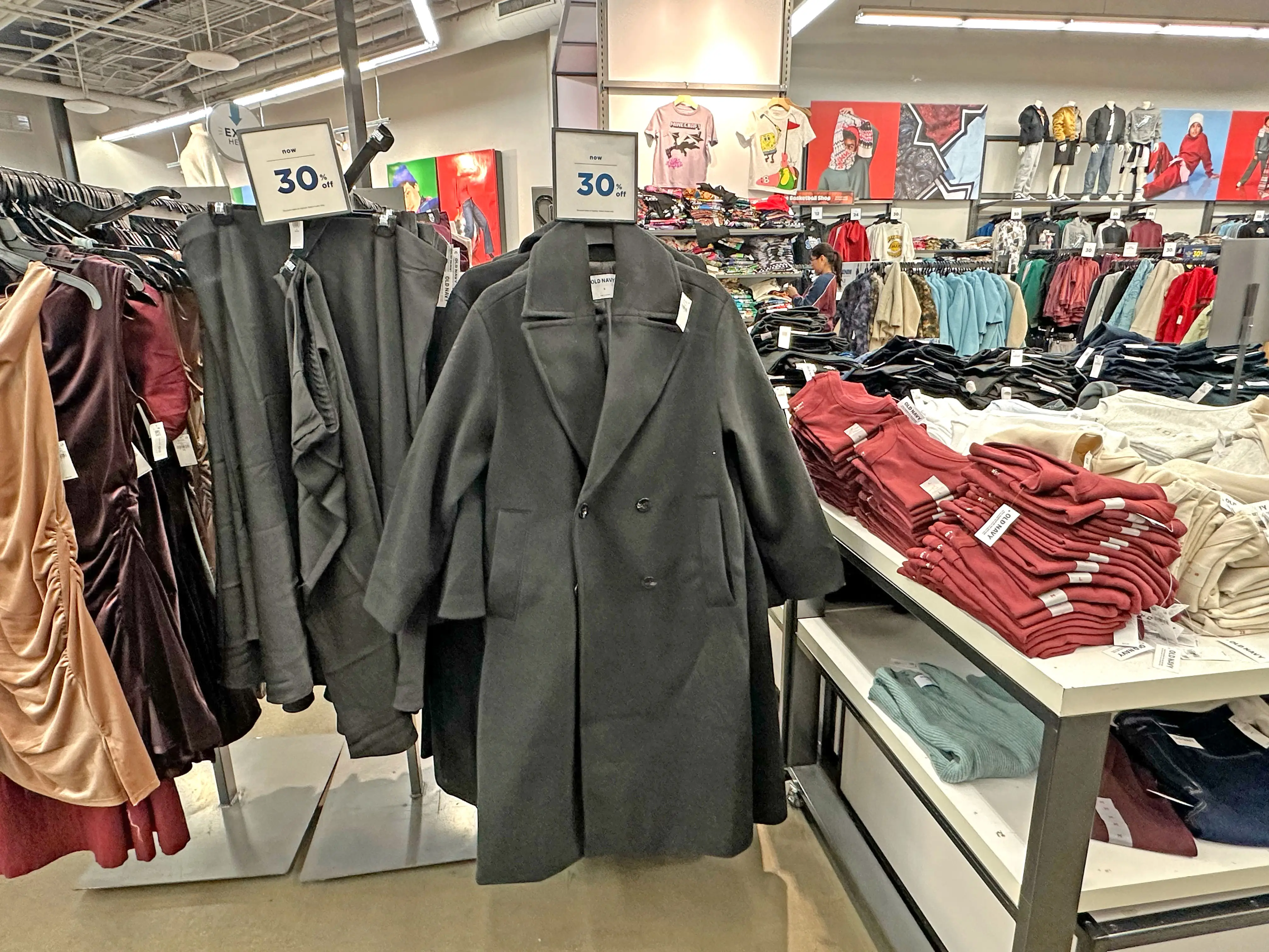 Racks of coats, pants, and dresses on display at Old Navy.