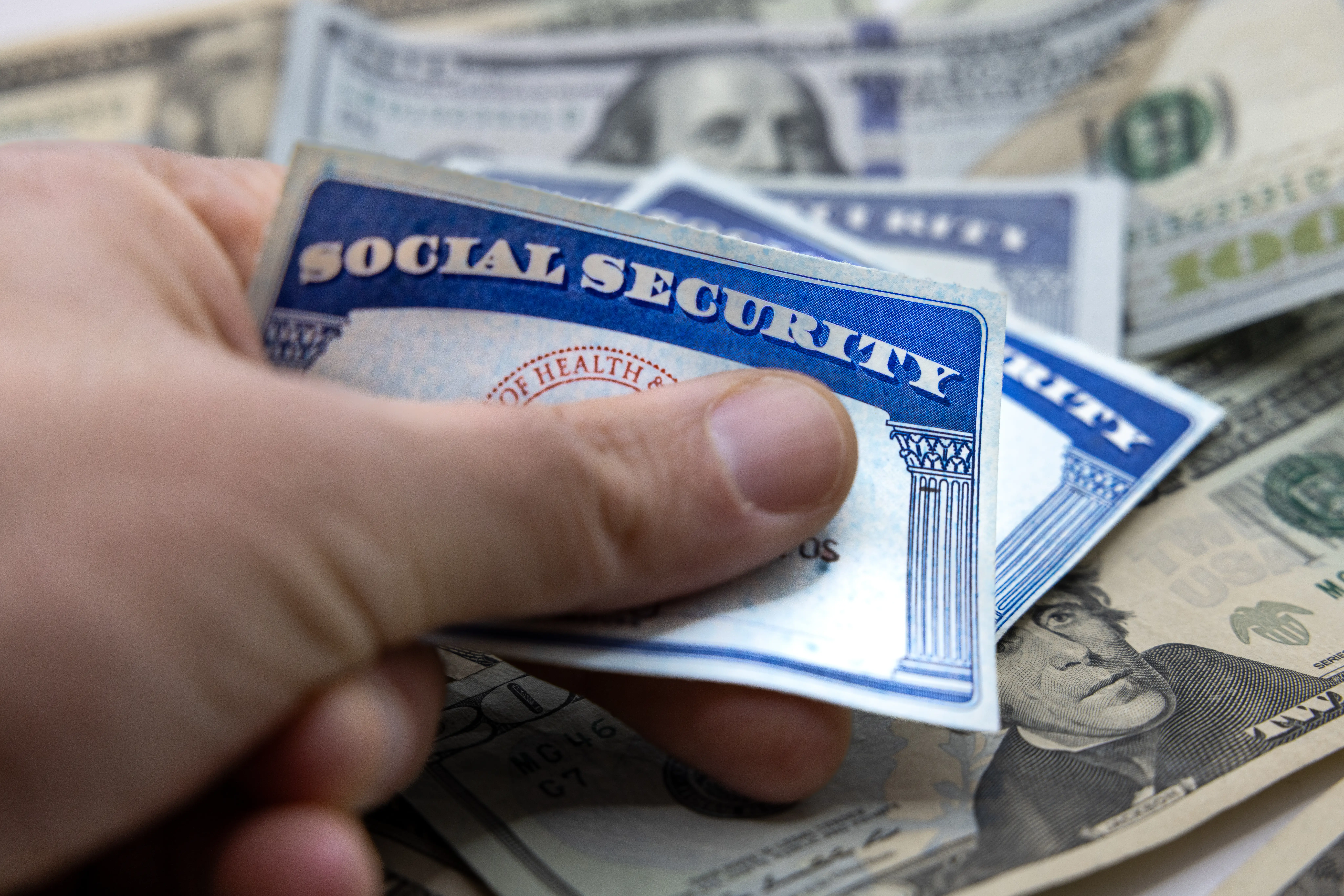 social security cards over dollars