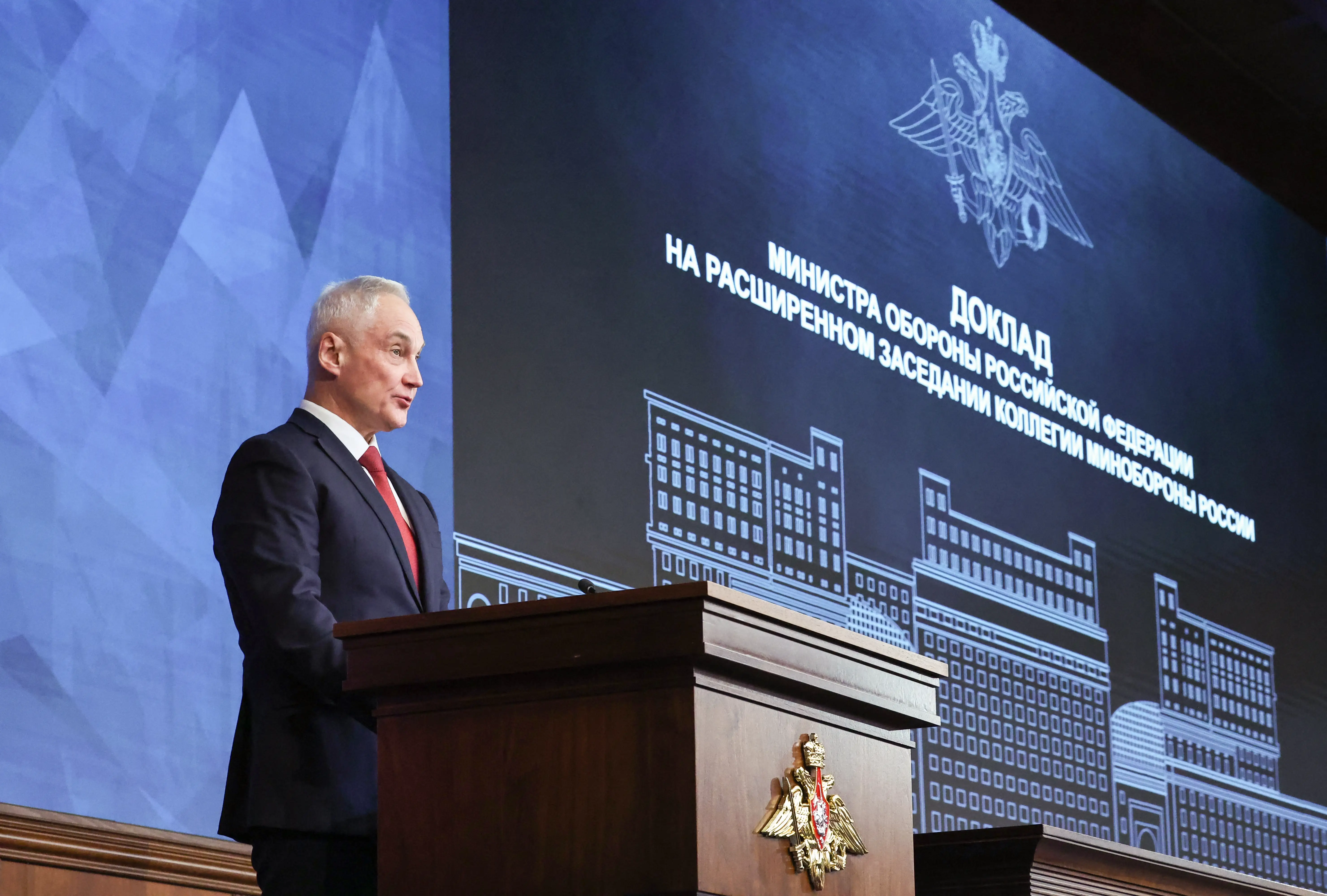 Russia's defense minister, Andrey Belousov, speaks at a podium.