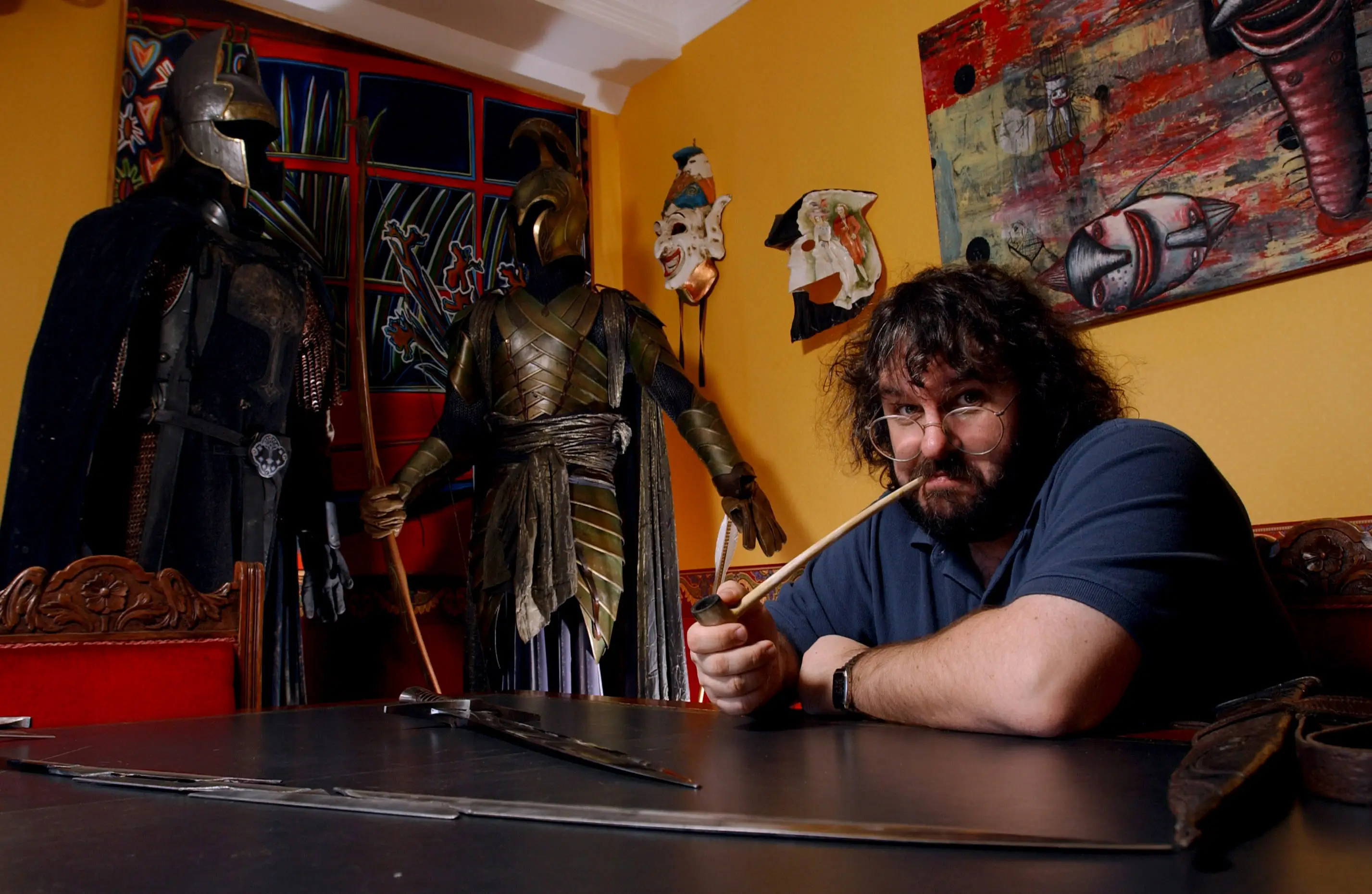 Peter Jackson sitting at his office with a long pipe in his mouth