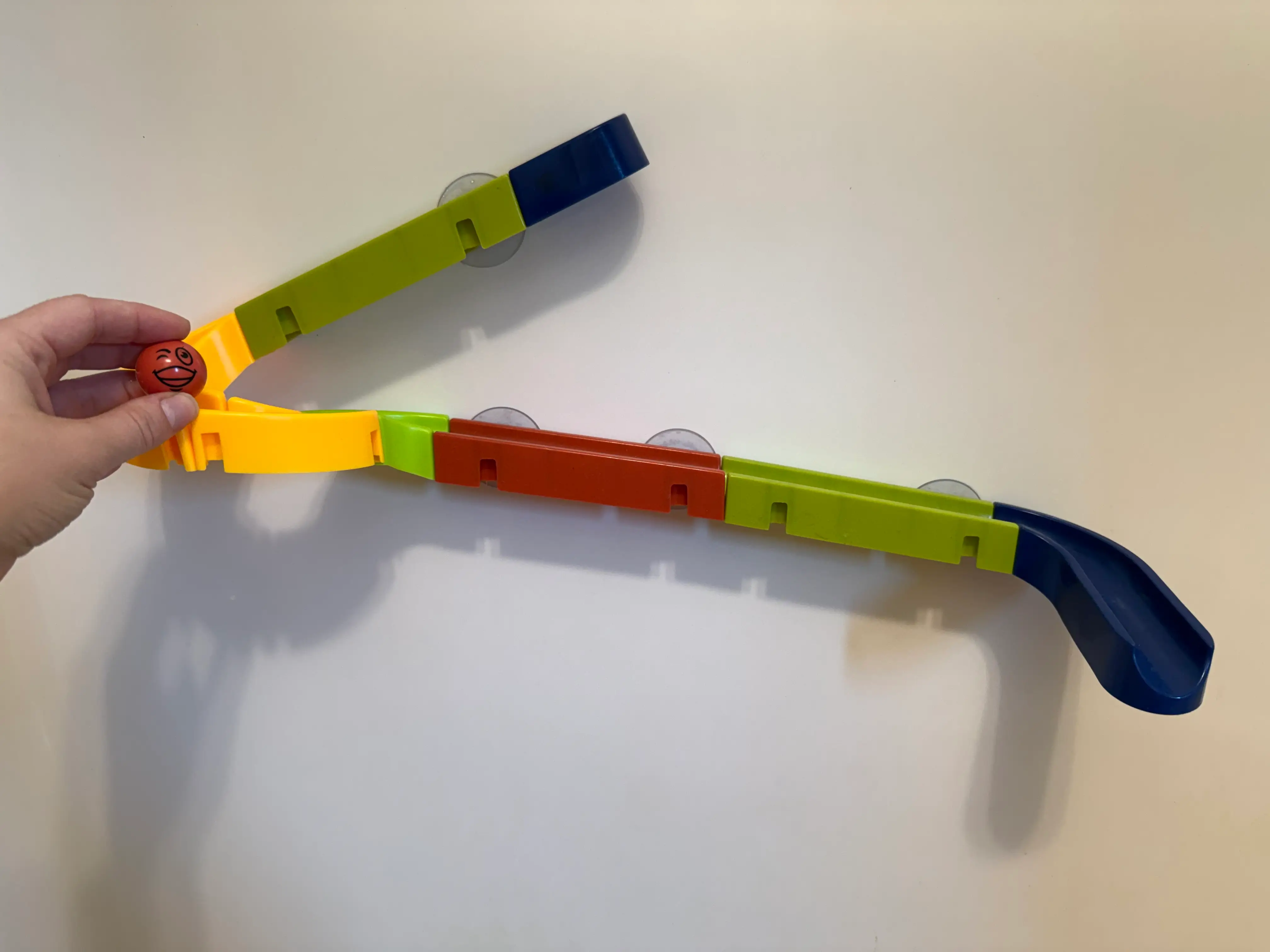 The author shows off a bath marble run toy.