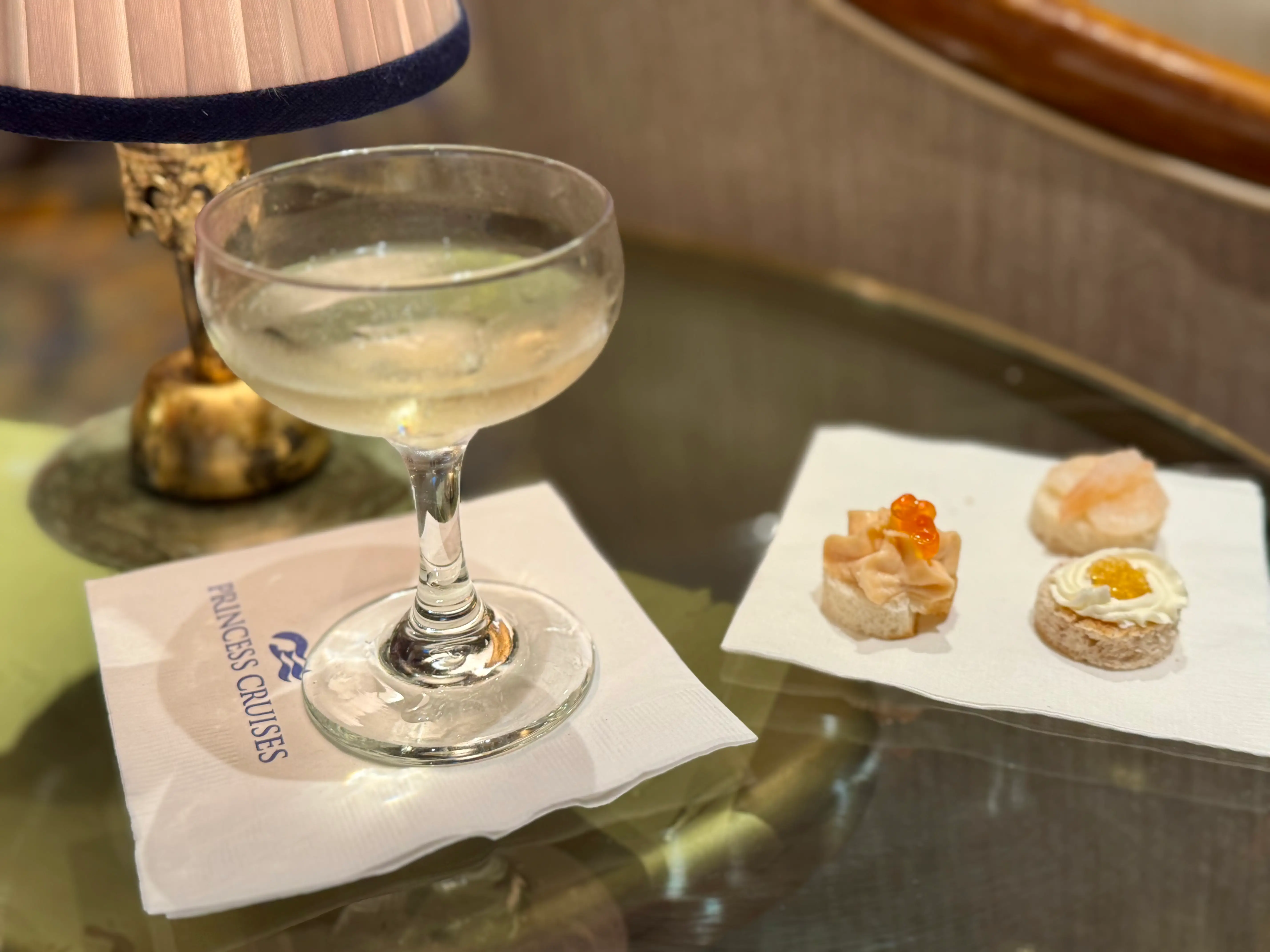 An alcoholic beverage and hors d'oeuvres on a table.