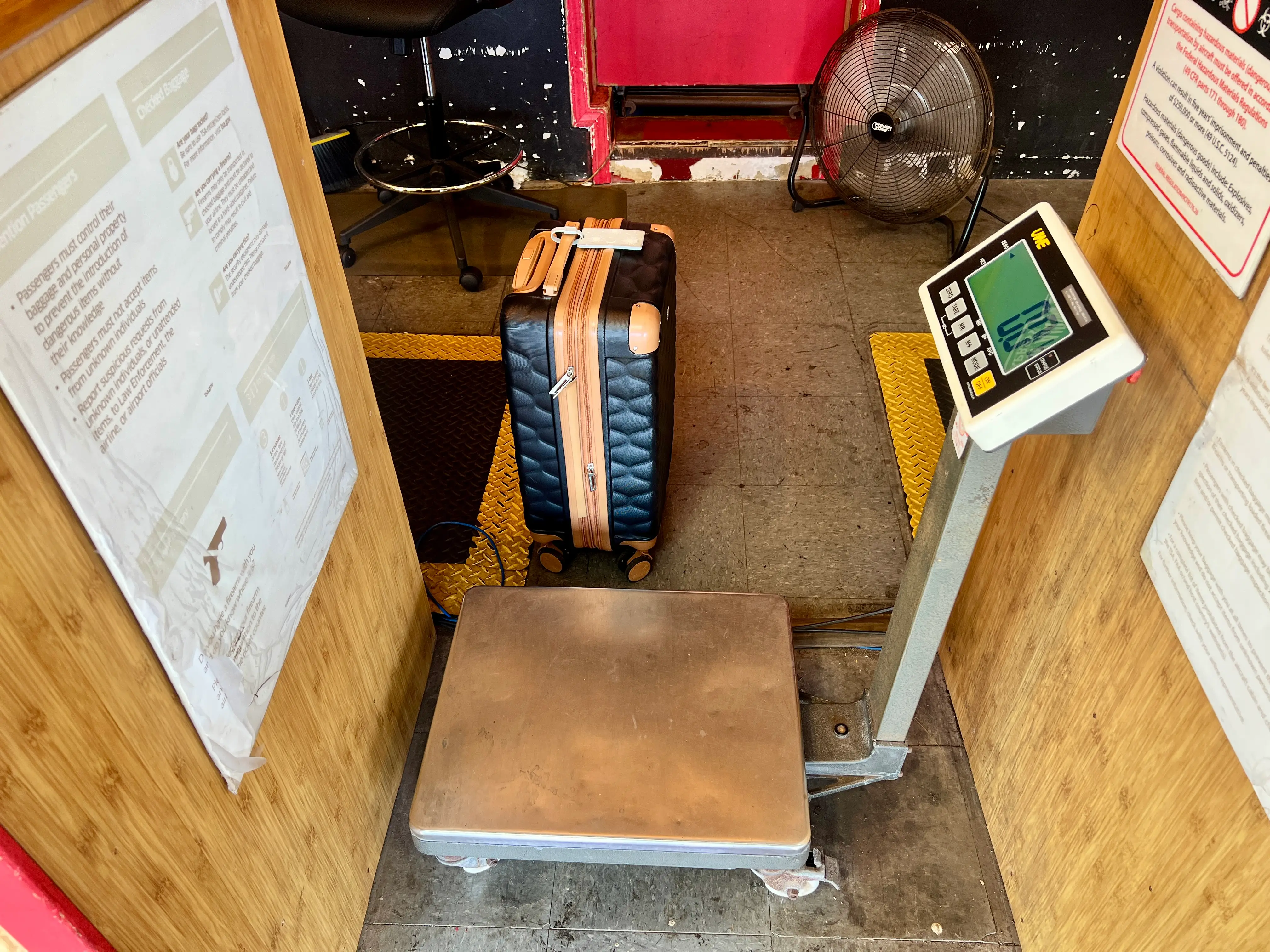 Luggage scale with bag behind it