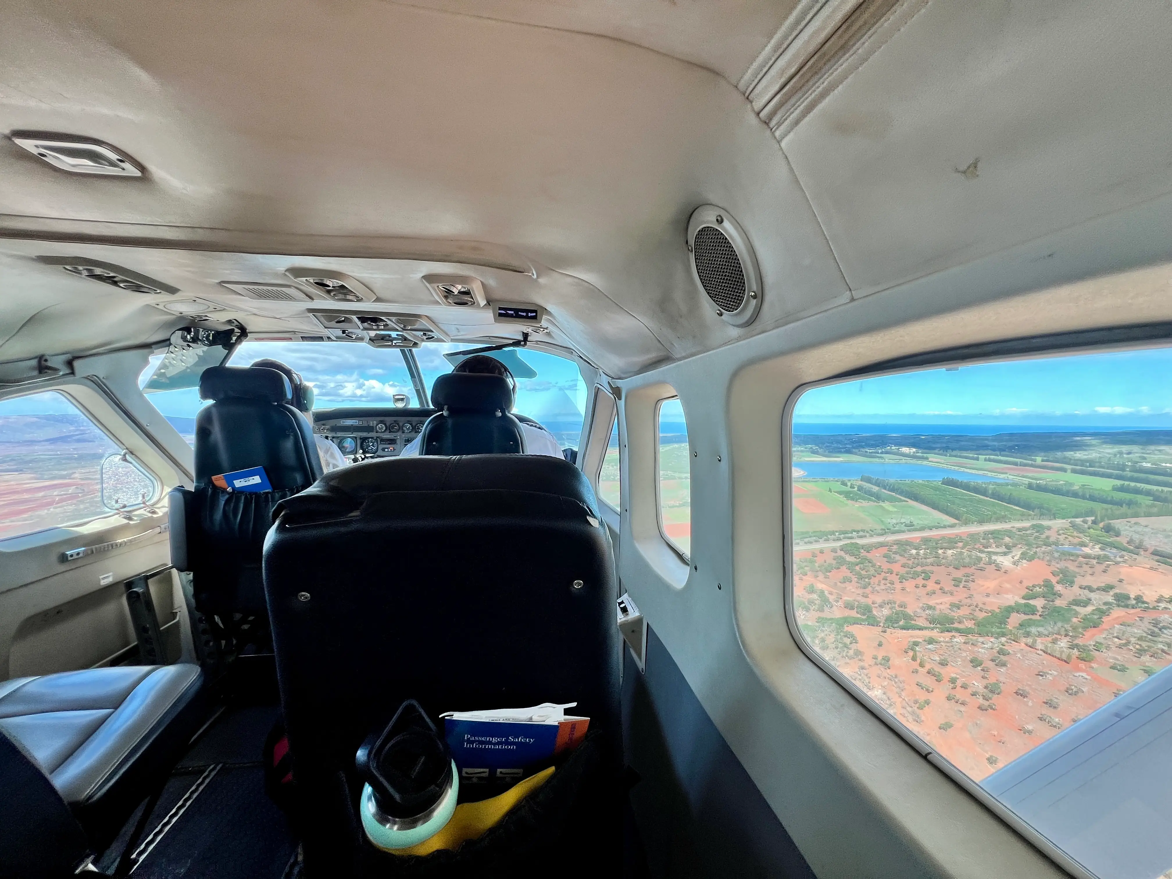 View of red dirt, farmland outside plane window