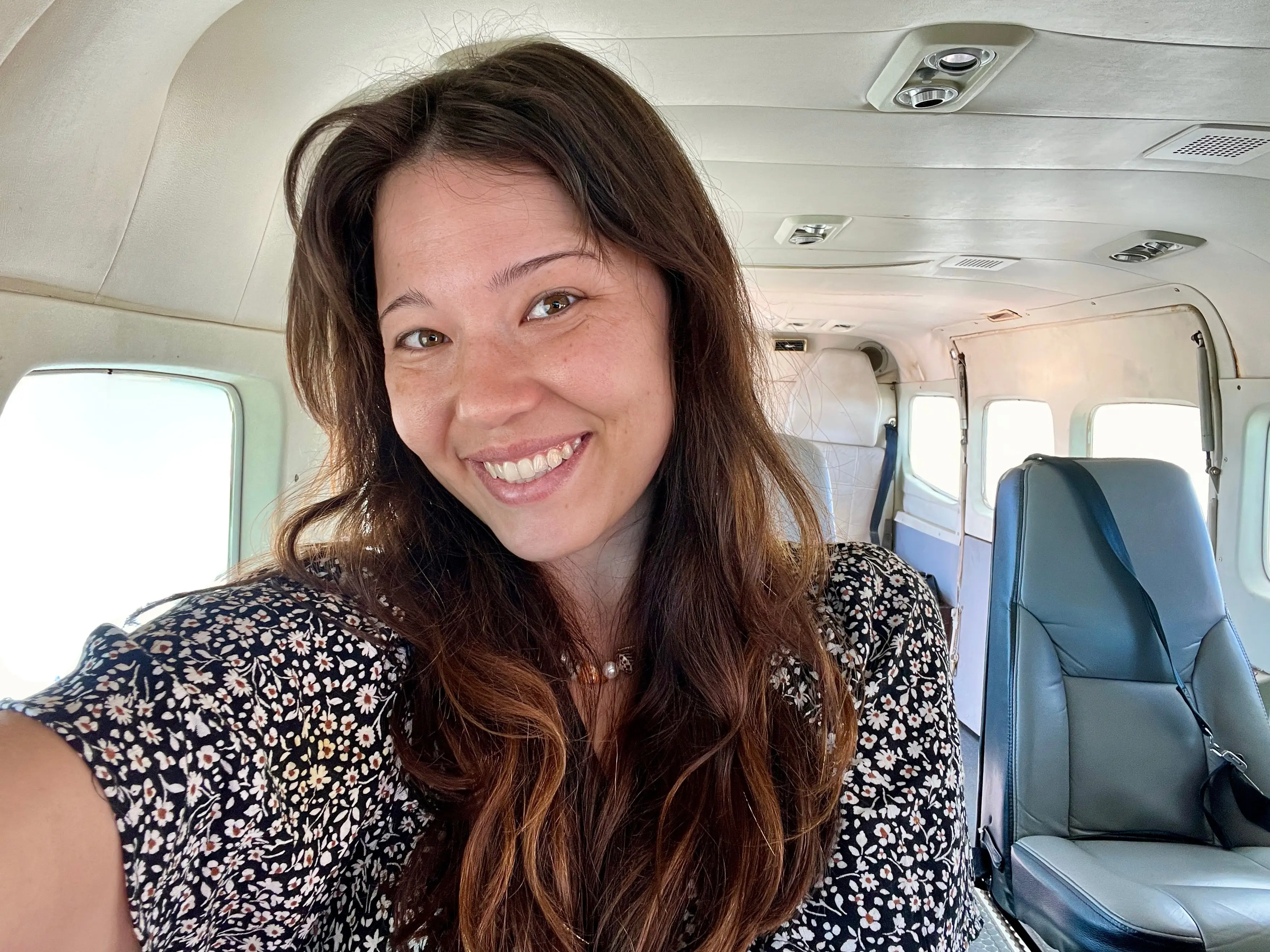 Author Ashley Probst smiling on plane in selfie