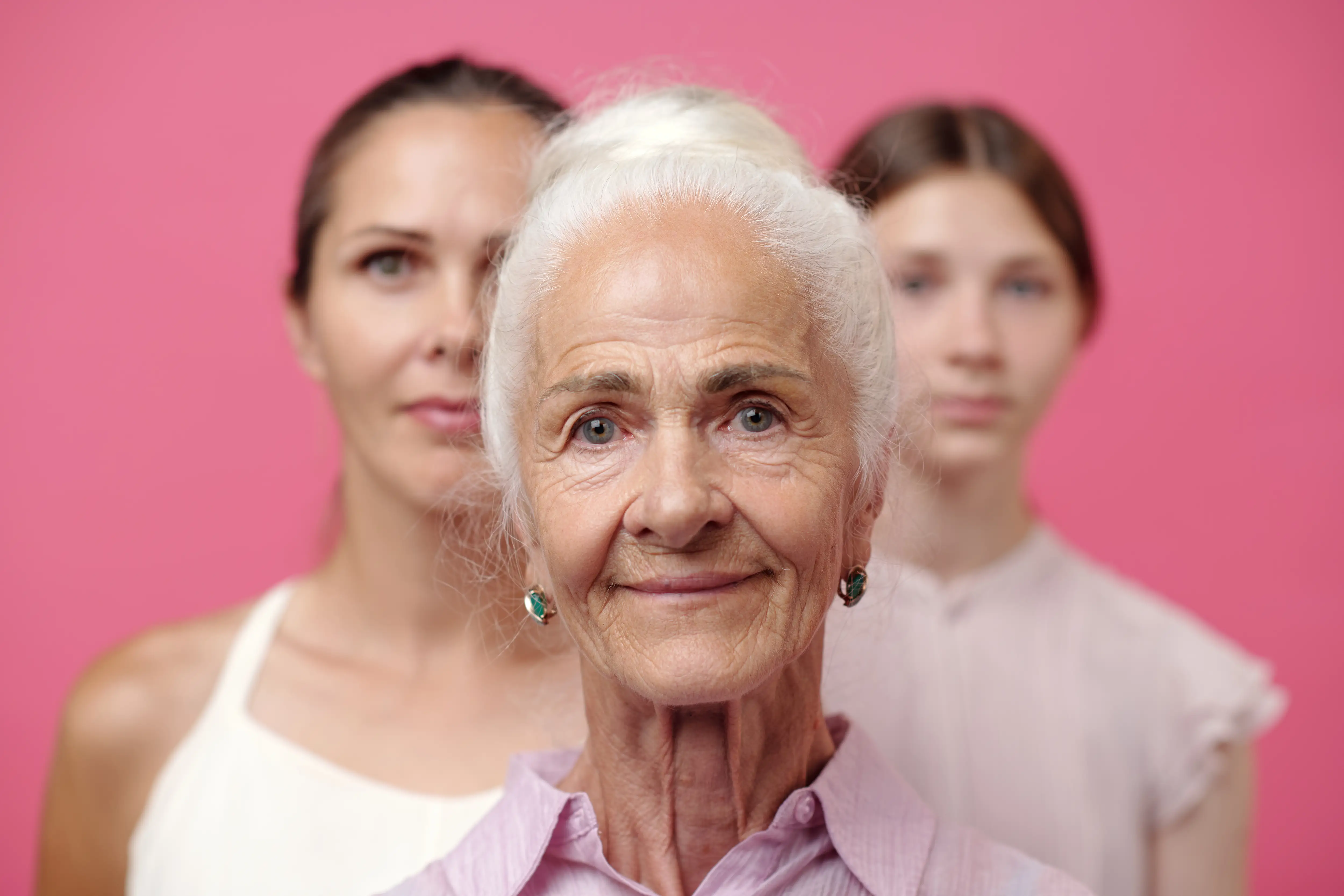 Three women of varying ages look at the camera.