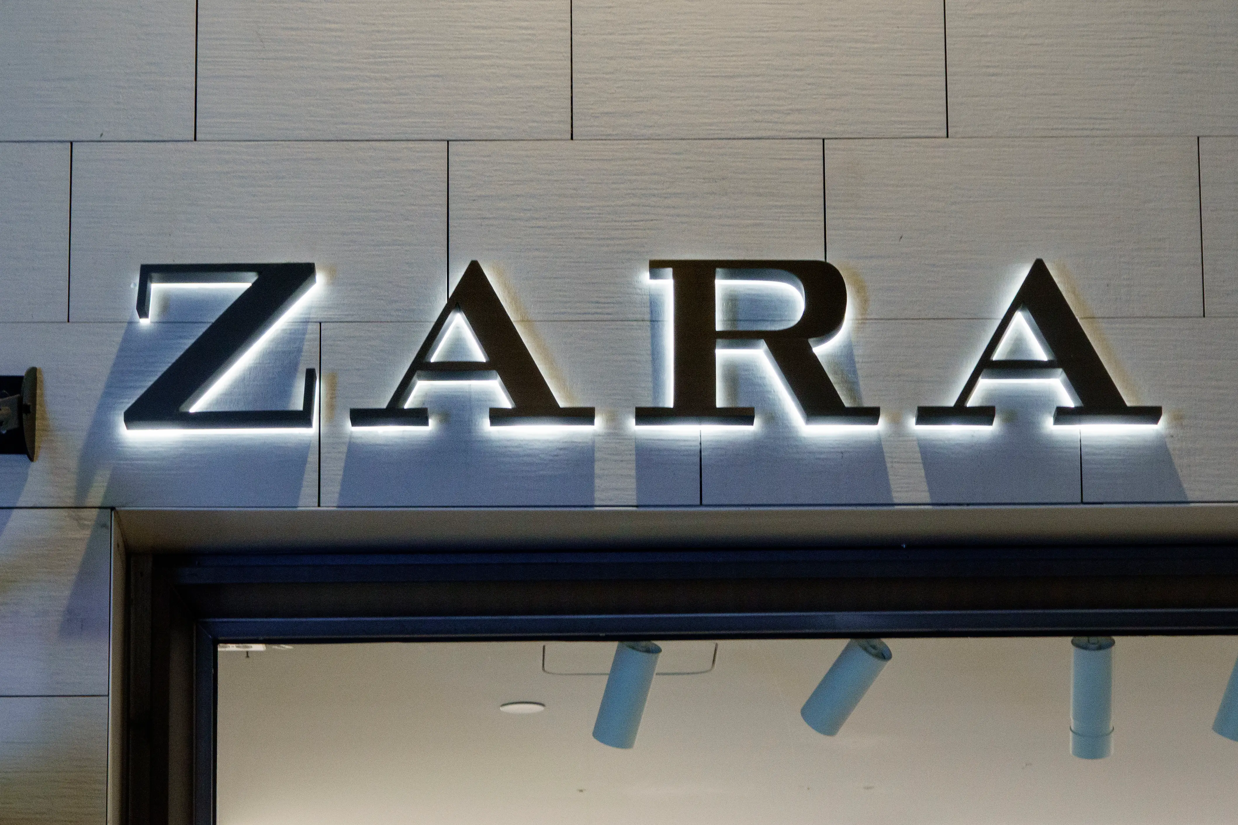 The Zara logo appears on a storefront.