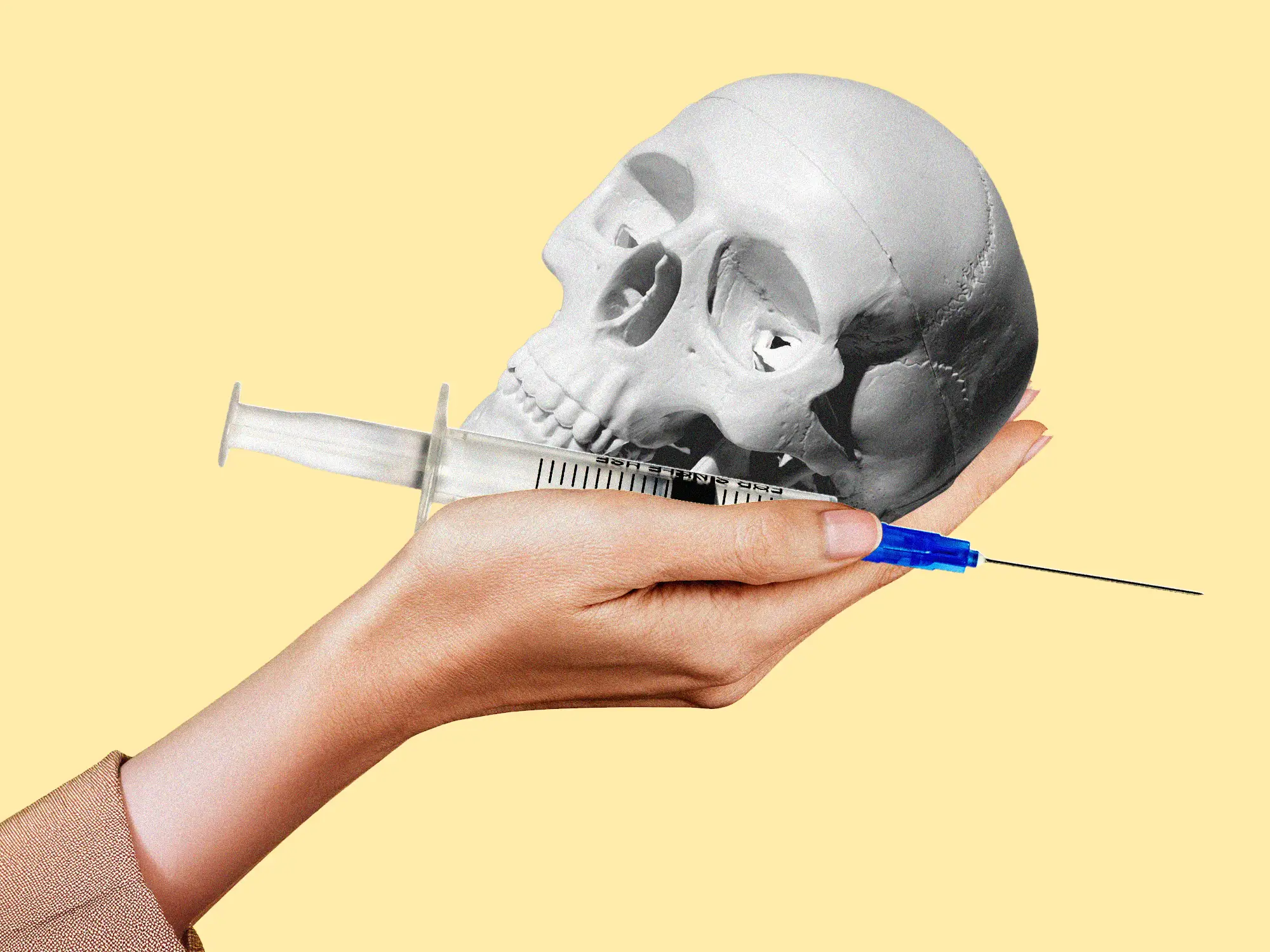 A hand holding a skull and a syringe