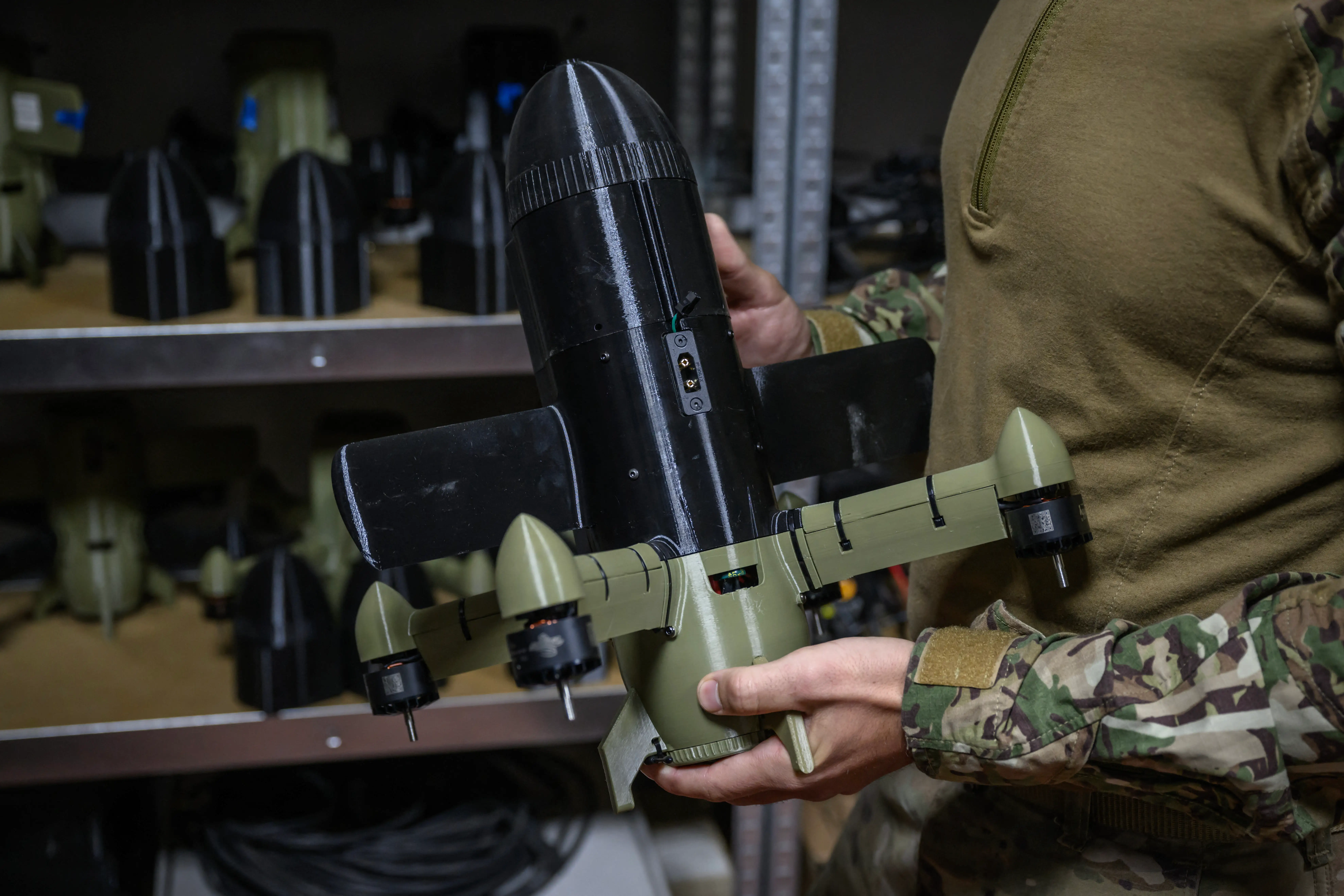 A Ukrainian soldier holds an interceptor drone.