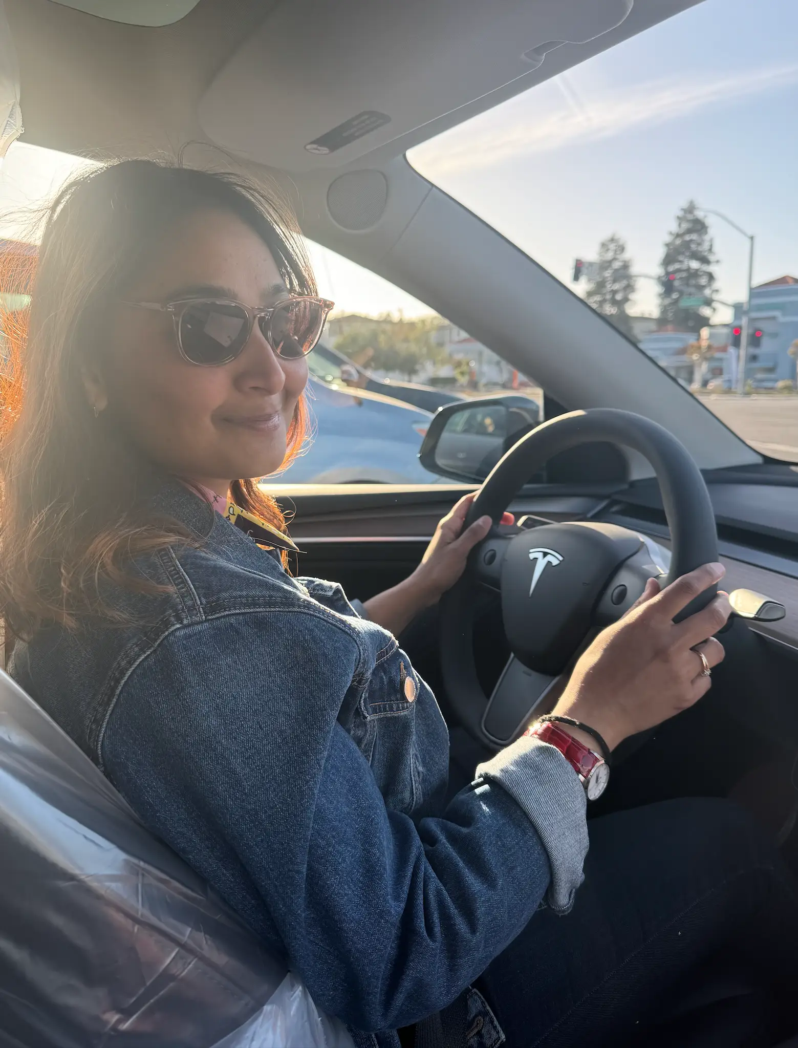Gangal in the driver's seat of her Tesla