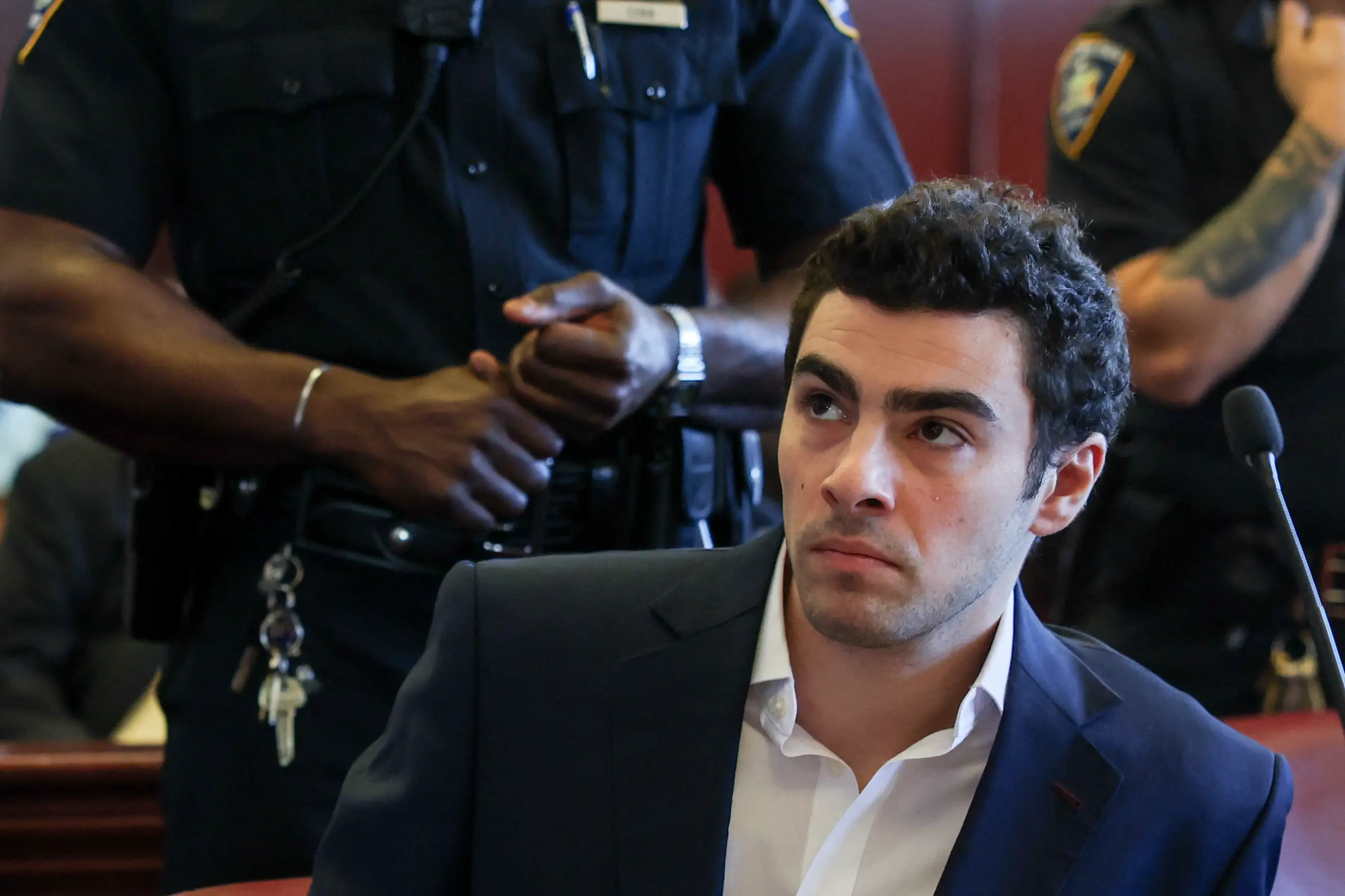 Luigi Mangione sits at the defense table in a state courtroom in Manhattan, attending evidence suppression hearings in the ambush shooting murder of UnitedHealthcare CEO Brian Thompson.