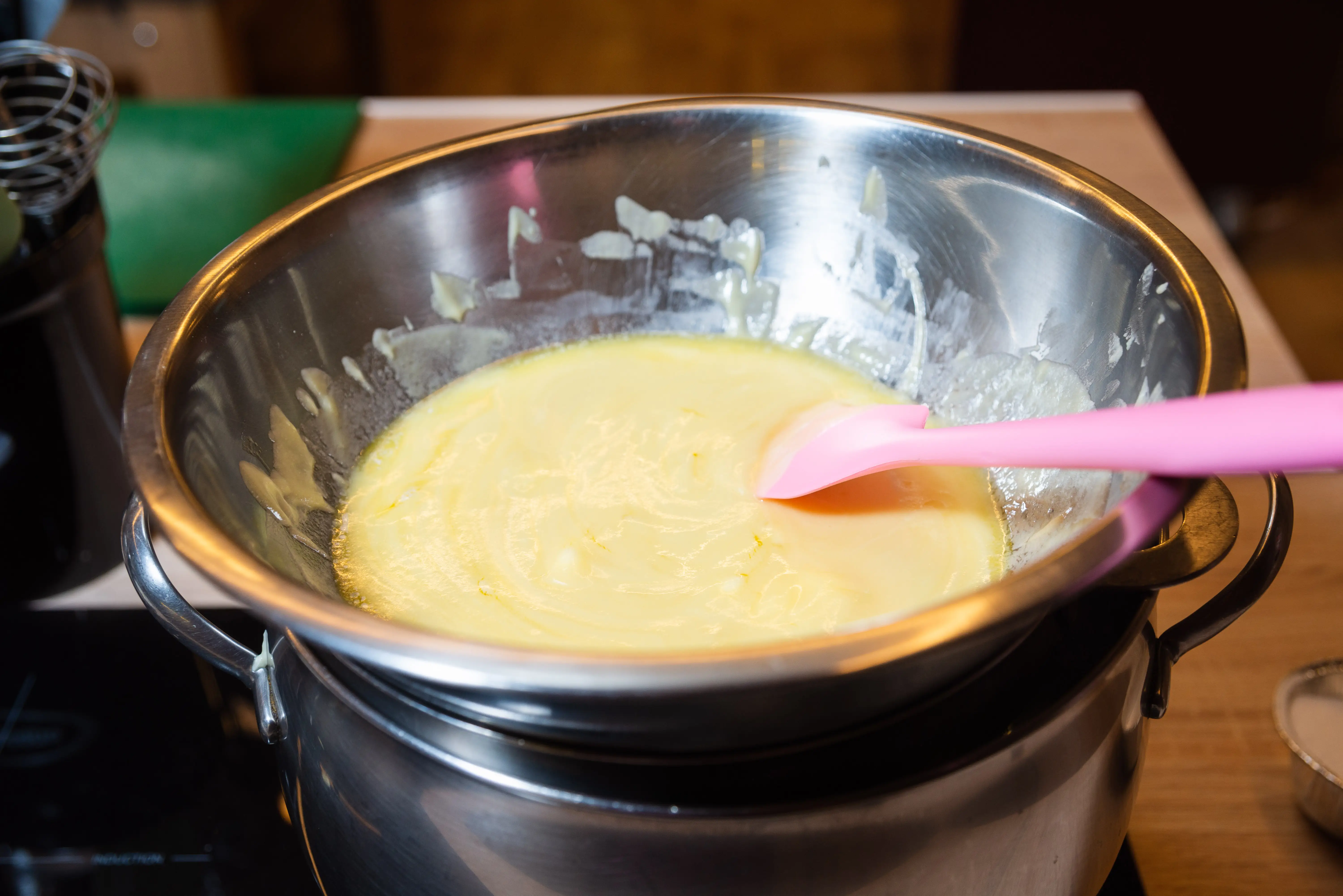 Custard mixture being stirred over double boiler