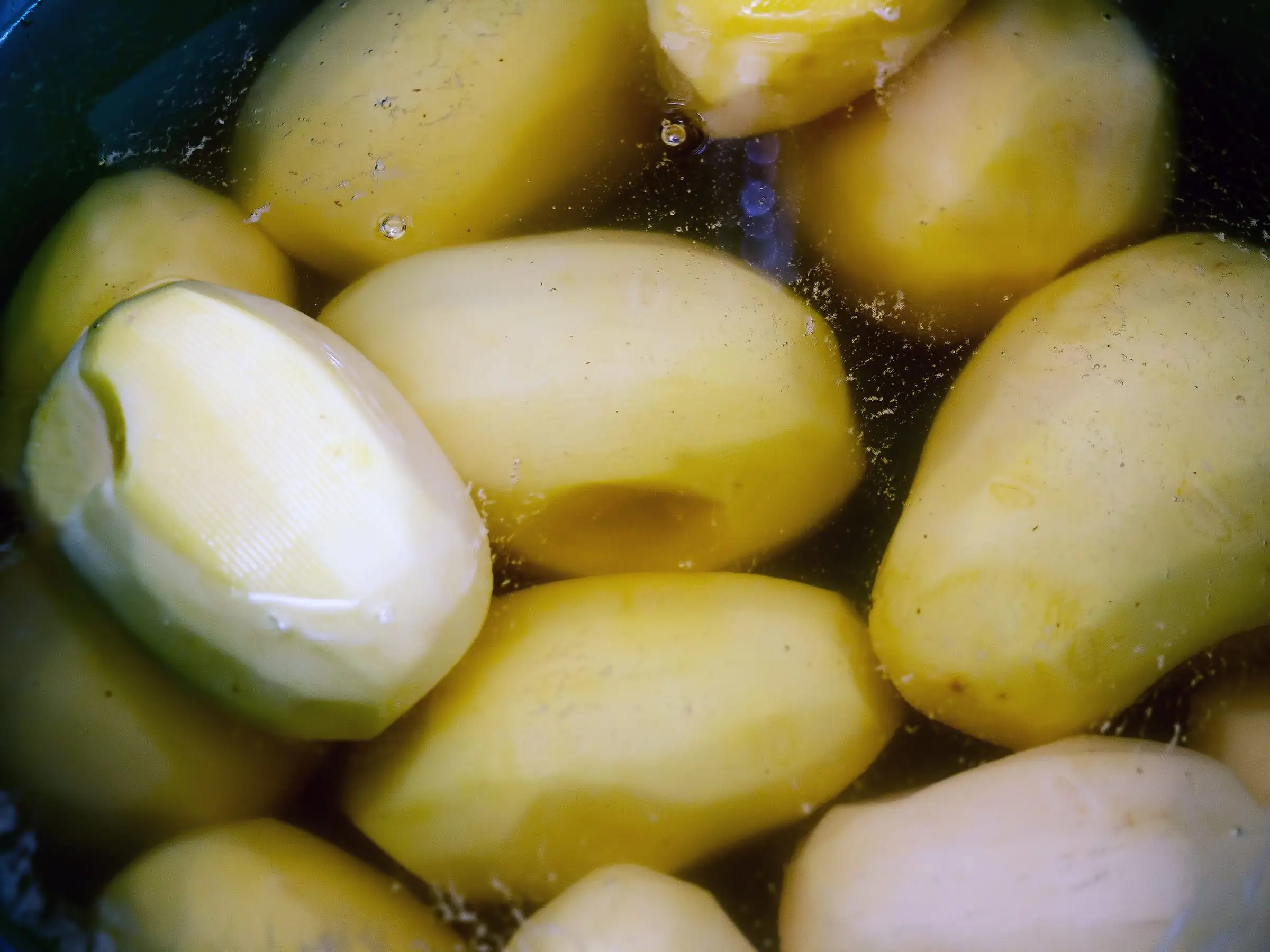 Peeled potatoes soaking in water
