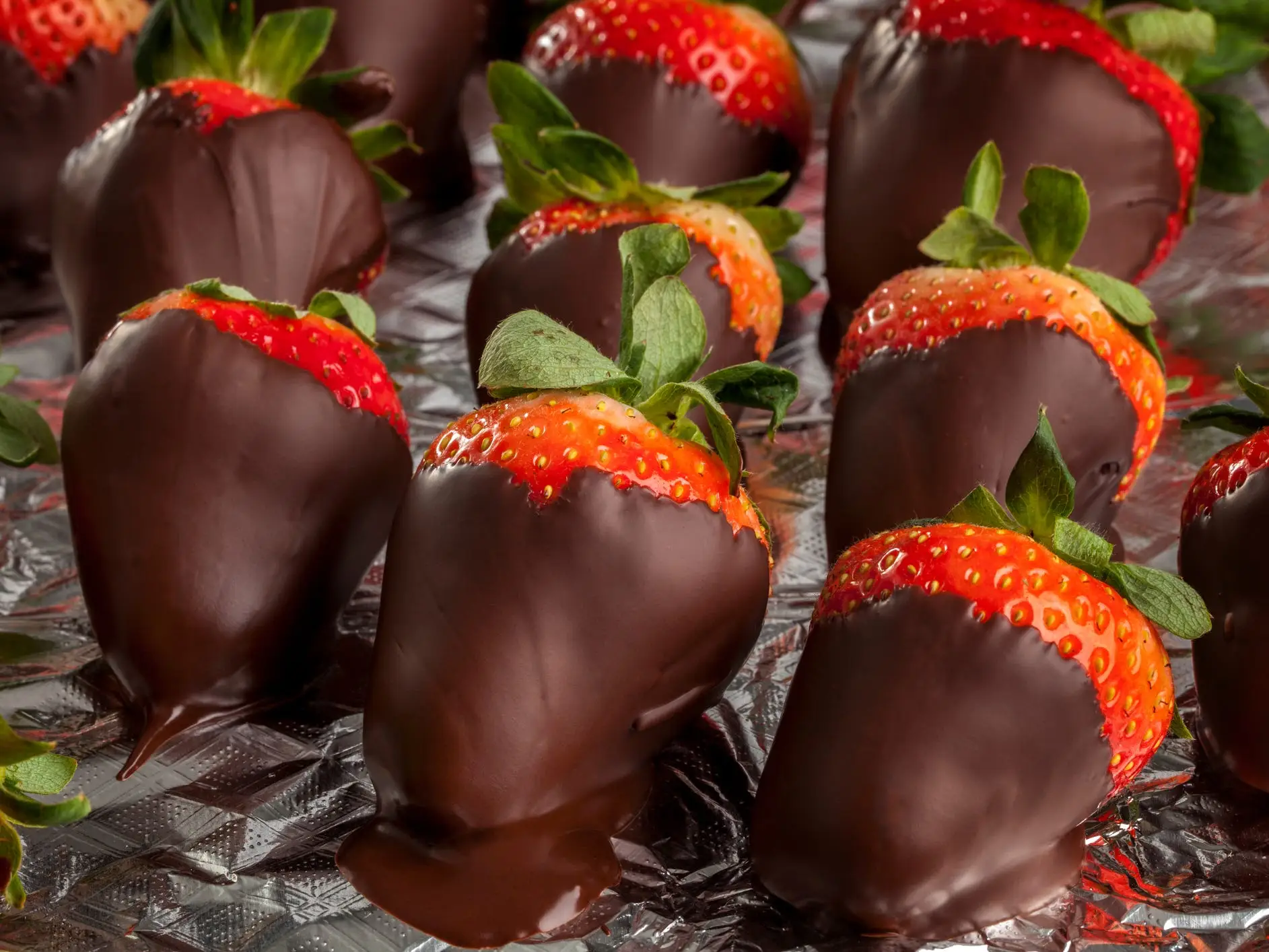 Rows of chocolate covered strawberries.