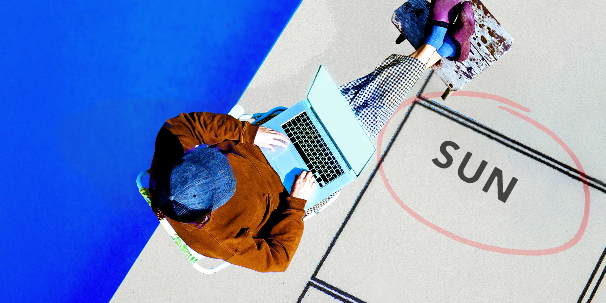 Overhead view of a man working on a laptop and an oversized calendar with Sunday circled.