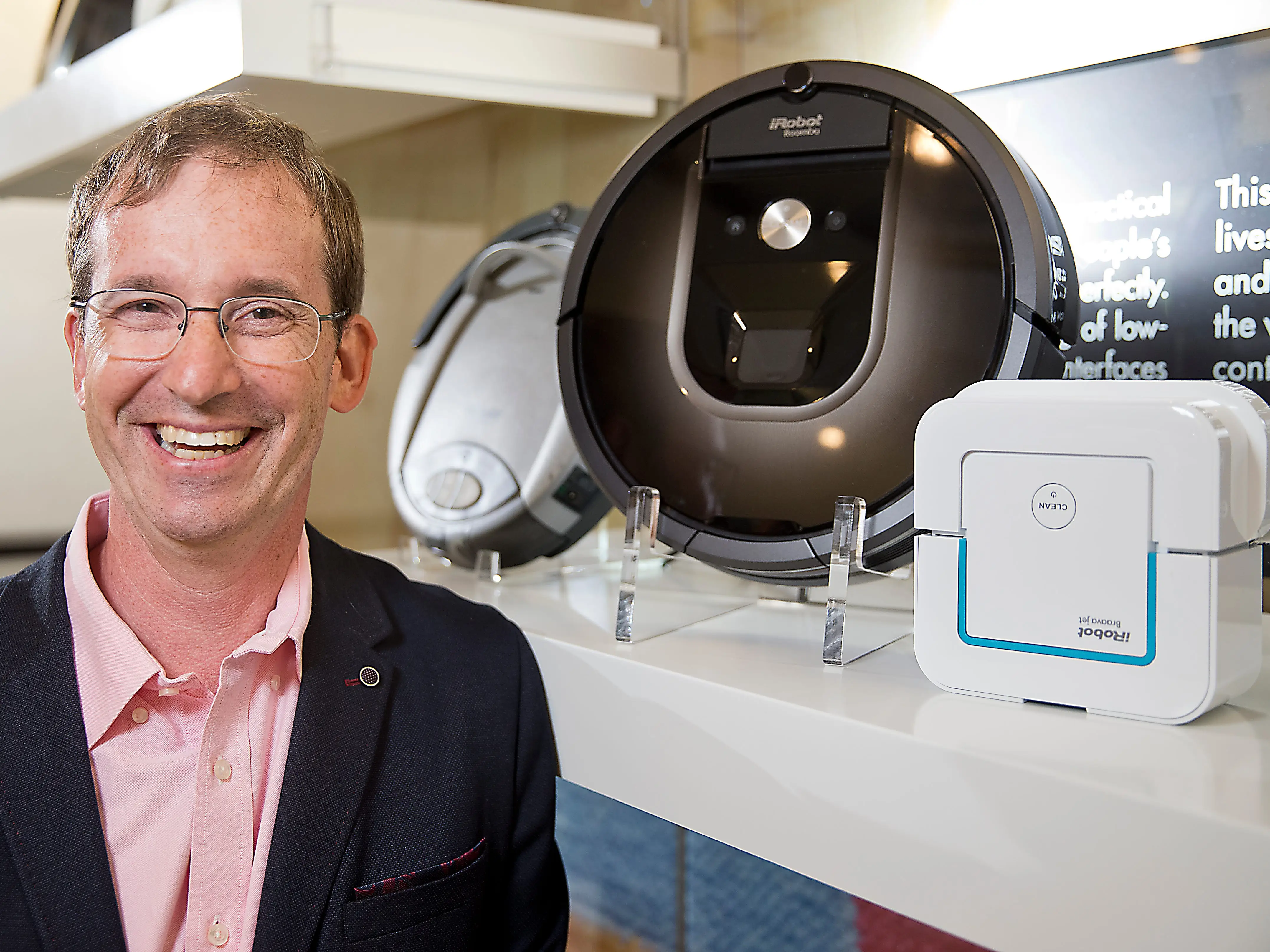 iRobot cofounder Colin Angle next to a Roomba.