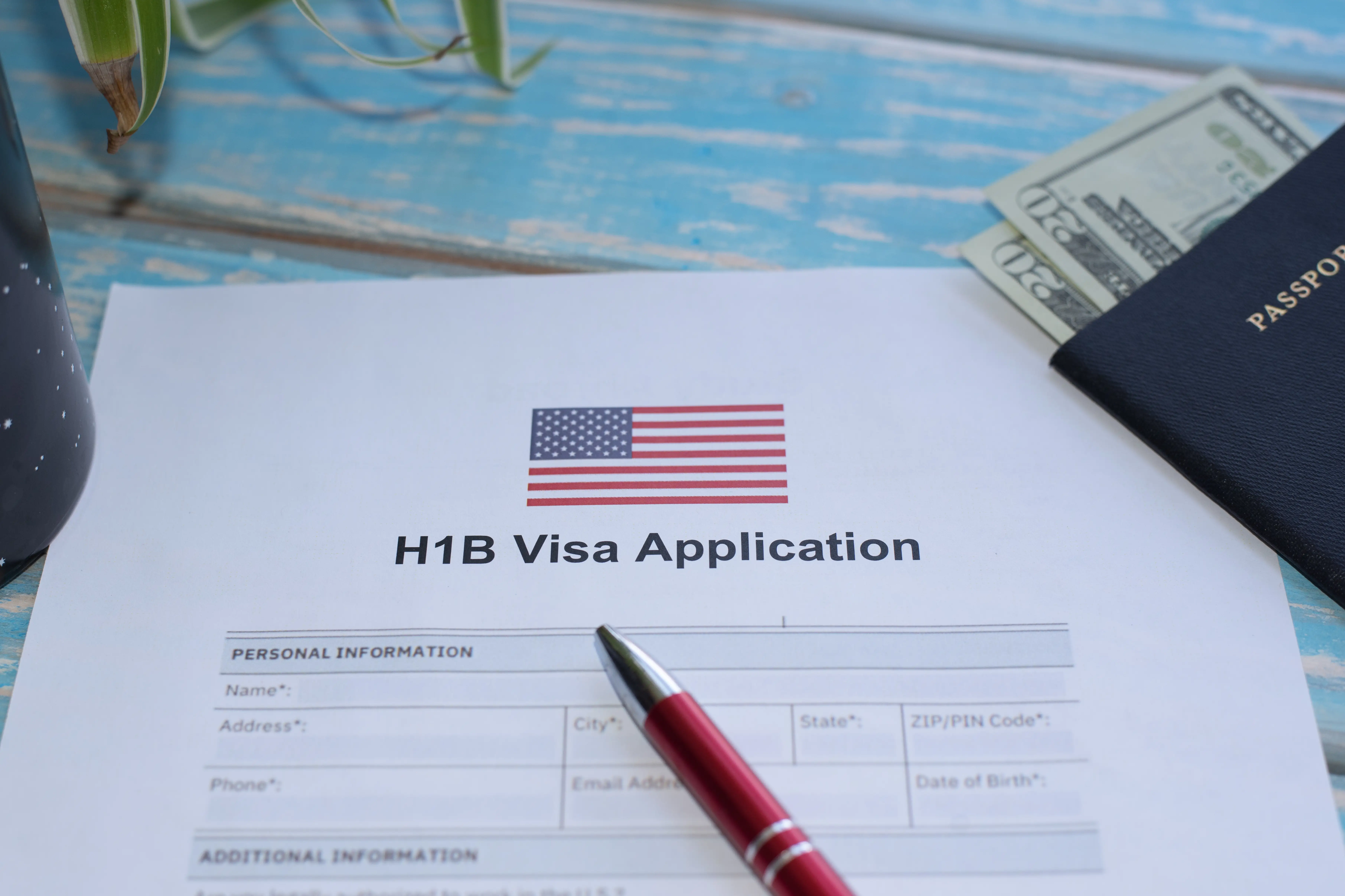 A pen on top of an H-1B visa application