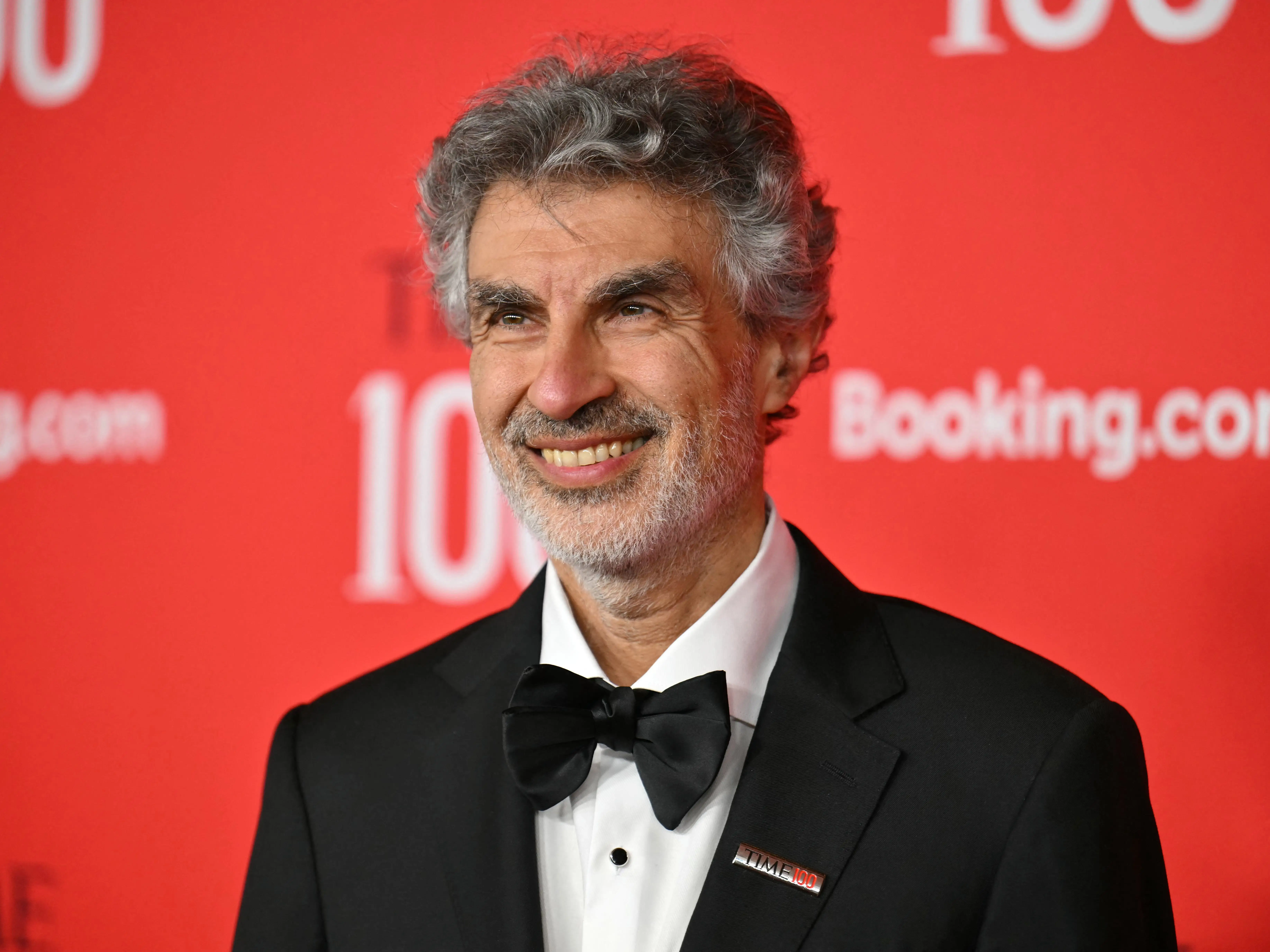 Yoshua Bengio wearing a black suit with a bowtie.
