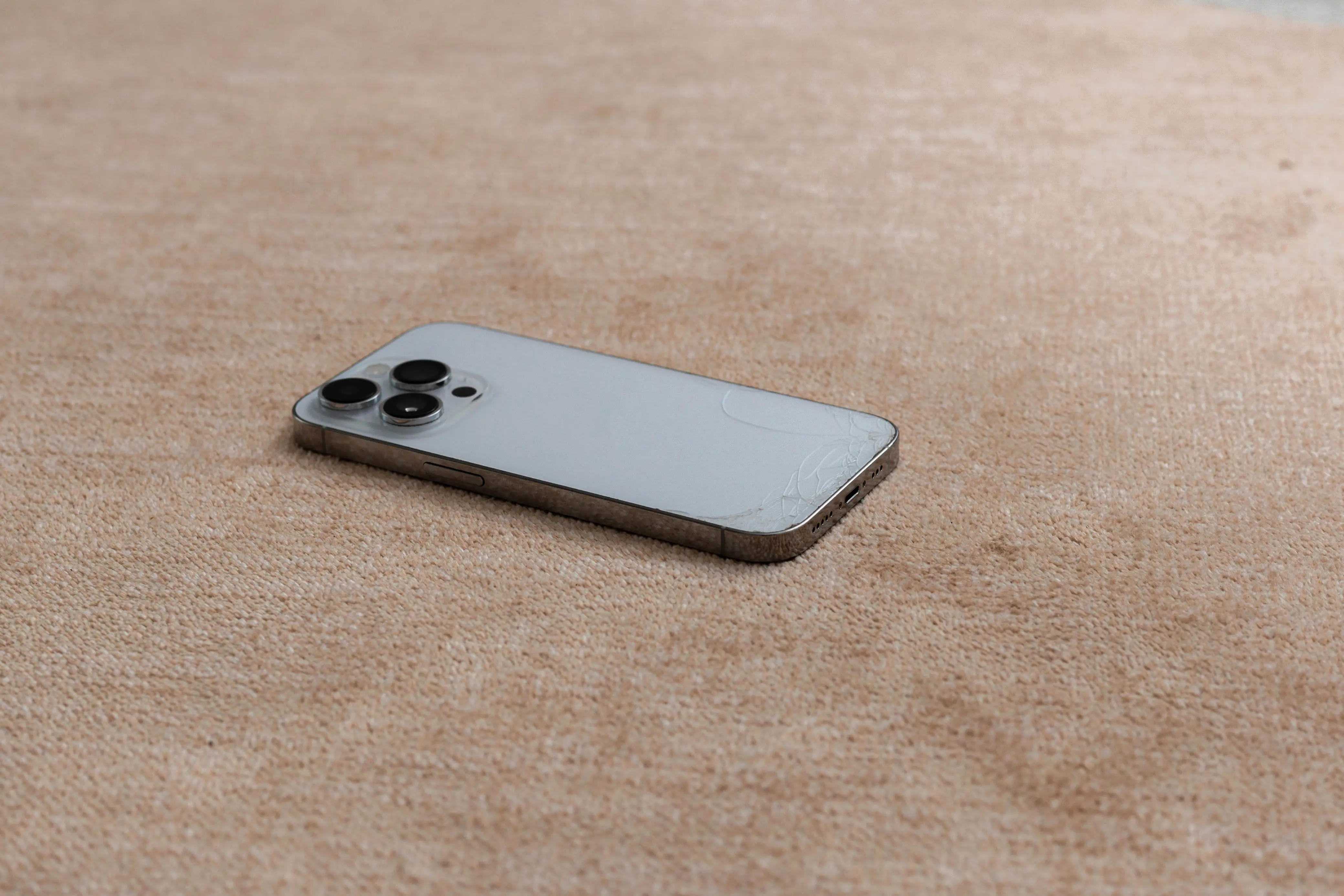 A cellphone lying face down on the floor