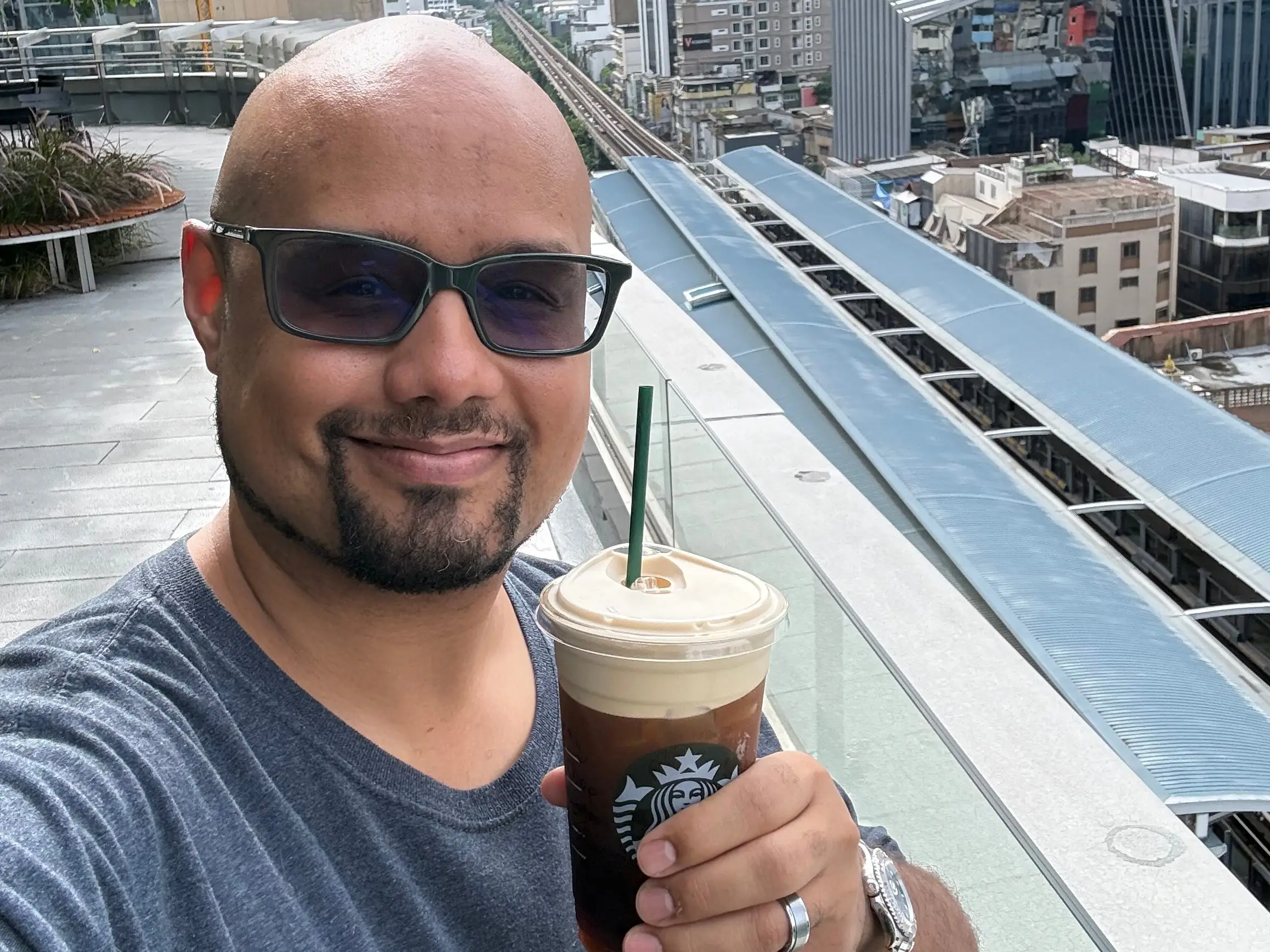 Kimanzi Constable holding up a starbucks cup