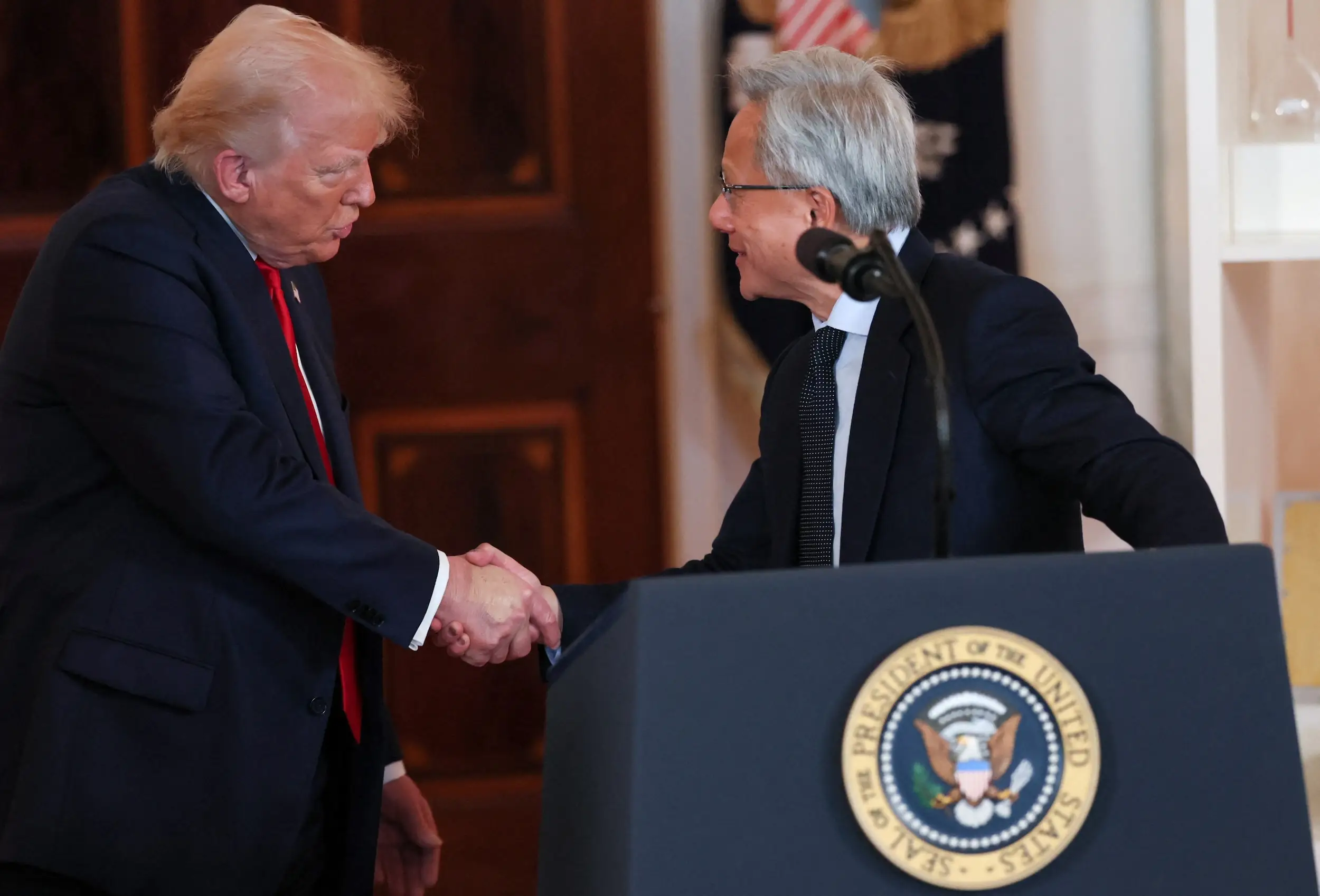 Donald Trump and Jensen Huang shake hands